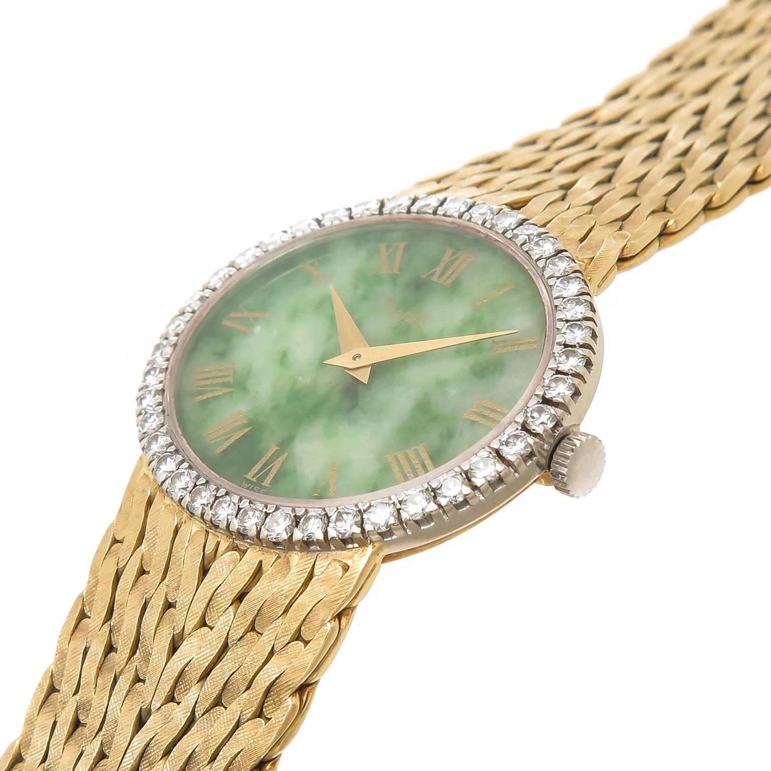 Circa 1980s Ladies Piaget Wrist Watch, 27 X 24 MM 18K Yellow Gold case, Factory Diamond bezel set with Round Brilliant cut Diamonds totaling 1 Carat, Green Nephrite Dial with Gold Hands. 17 Jewel Mechanical, manual wind movement.  5/8 inch wide 18K