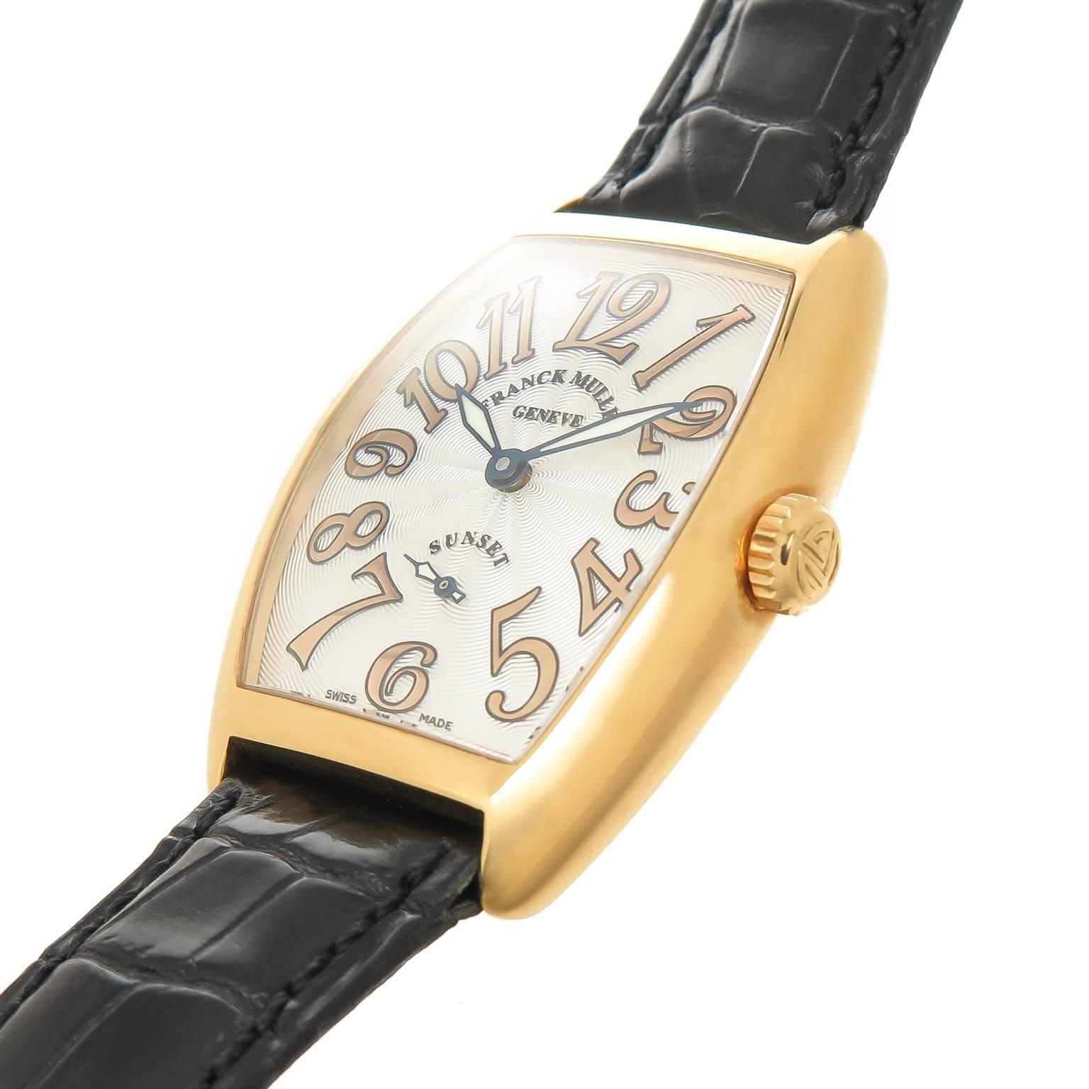Circa 2005 Franck Mueller Sunset Collection Wrist Watch, 18K yellow Gold 38 X 29 MM Tonneau , curvex Water resistant case. Mechanical, Manual wind movement. Silver Engine turned Guilloche Dial with Gold Markers. Scratch resistant Synthetic Sapphire
