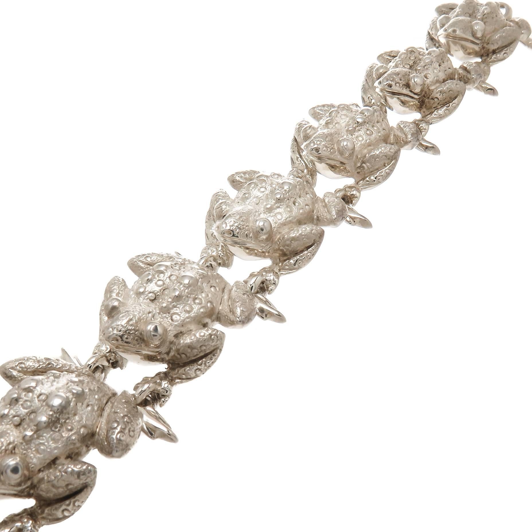 Circa 1980 Tiffany & Company sterling silver Bull Frogs Bracelet. Nice Heavy individually linked Bull Frogs, very detailed and textured. A very scarce Tiffany Piece. Measuring 7 1/2 Inch in Length and 1 inch wide. Comes in a Tiffany Felt storage