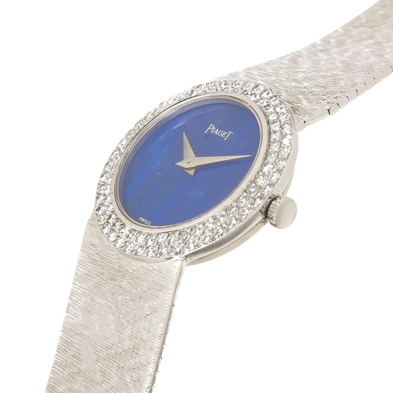 Circa 1980 Piaget Ladies Wrist watch, 24 MM 18K White Gold case with Factory Double Row Diamond set bezel totaling approxi mately 1.50 Carat. Mechanical, manual wind Movement, Lapis Lazuli Dial with White Gold hands. 5/8 inch wide 18K White Gold
