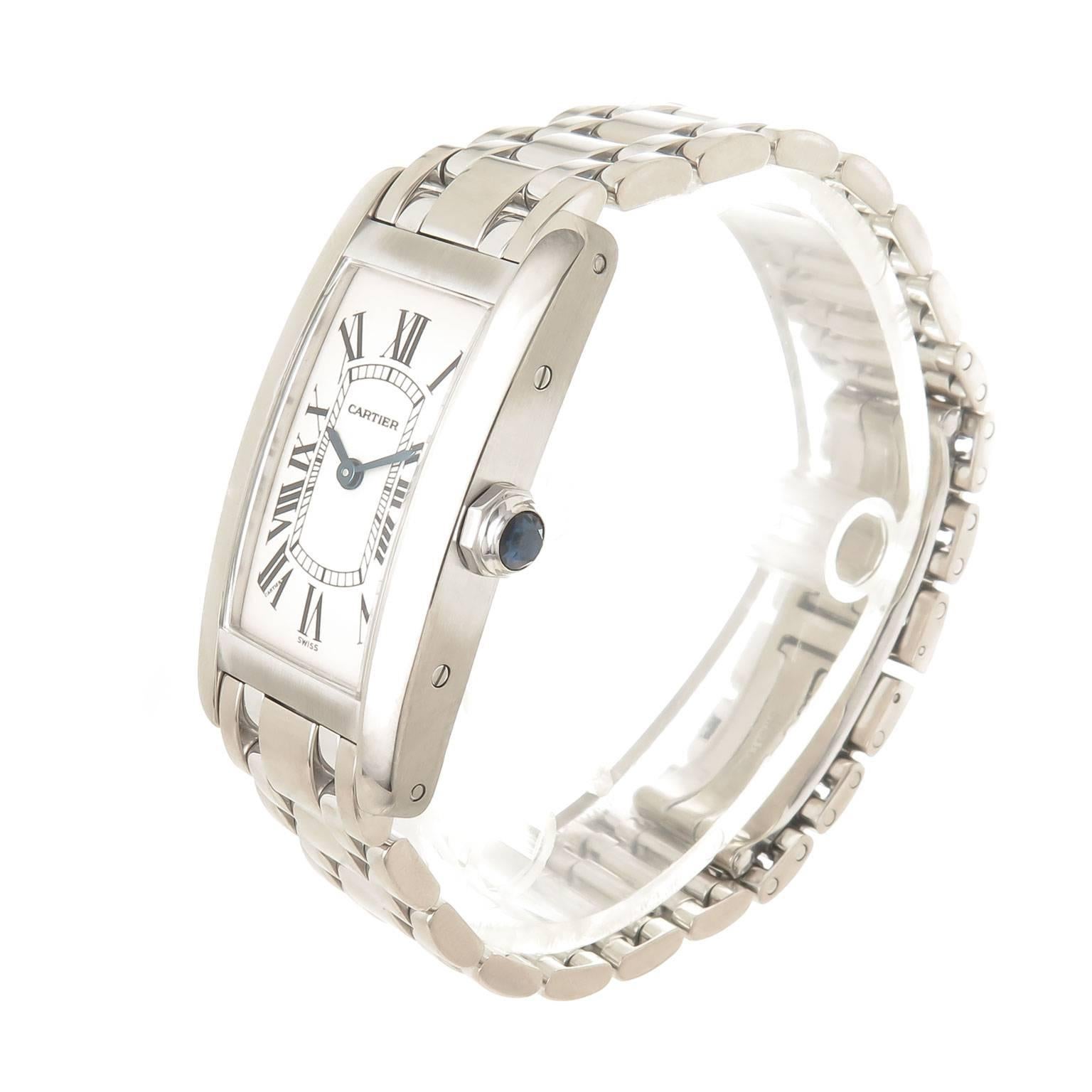 Circa 2005 Cartier Tank American Ladies Wrist watch, 35 MM in length and 19 MM wide 18K White Gold water resistant case. Quartz Movement, White Dial with Black Roman Numerals, scratch resistant crystal and a Sapphire Crown. 1/2 inch wide 18K White