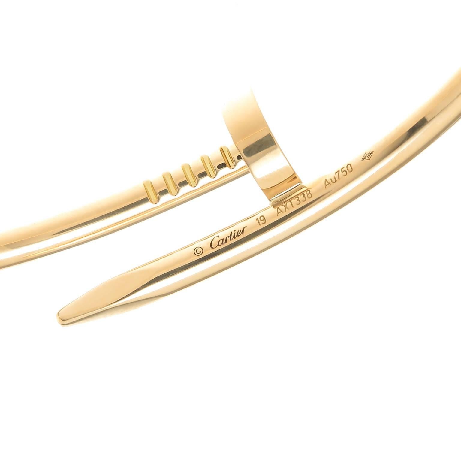 Circa 2014 Cartier Just Un Clou 18K yellow Gold size 19 Nail Bracelet. Signed and Numbered and comes in original Cartier Suede travel pouch. 