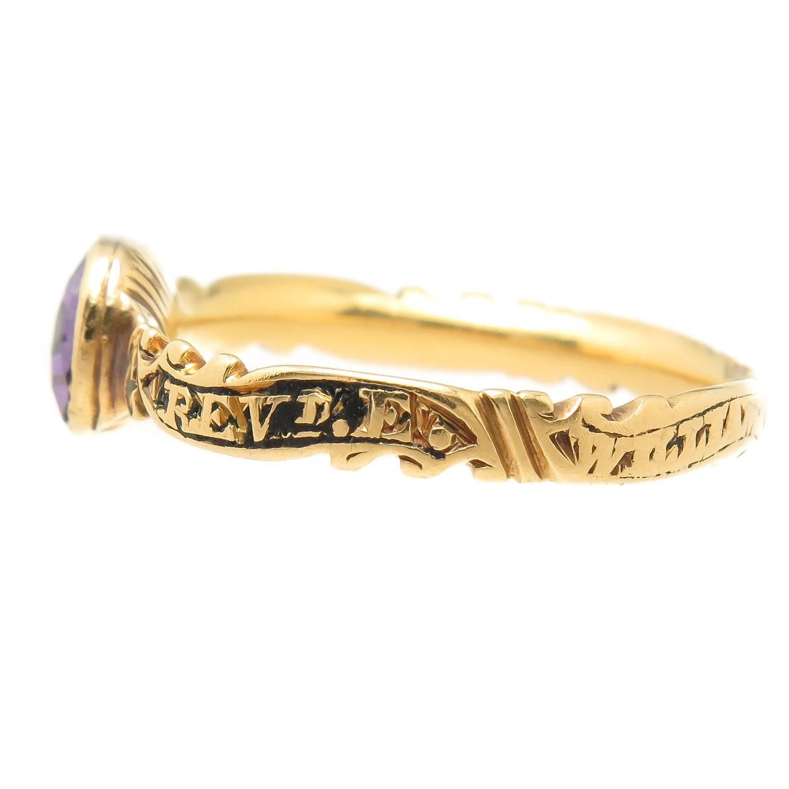 Circa 1763 Yellow Gold Memorial Ring, centrally set with an Amethyst and having Black Enamel. Engravings throughout the ring, some obscured with the dates clearly visible. The ring measures 1/8 inch wide and the finger size is 8 3/4. 
