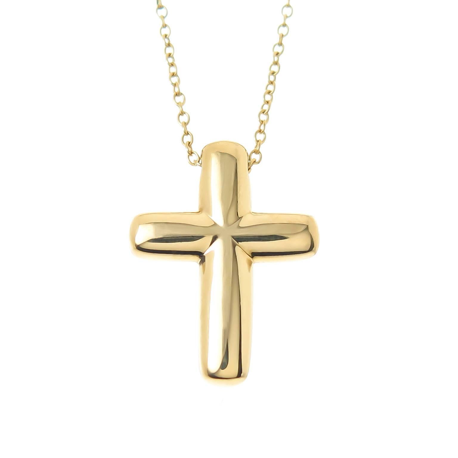 Circa 2010 Tiffany & Co 18k yellow Gold Cross, measuring 3/4 inch in length and  5/8 inch wide. Set with 4 Round Brilliant cut Diamonds totaling .10 Carat. Suspended from an 18 inch Yellow Gold Tiffany Chain. Comes in the original Tiffany Suede