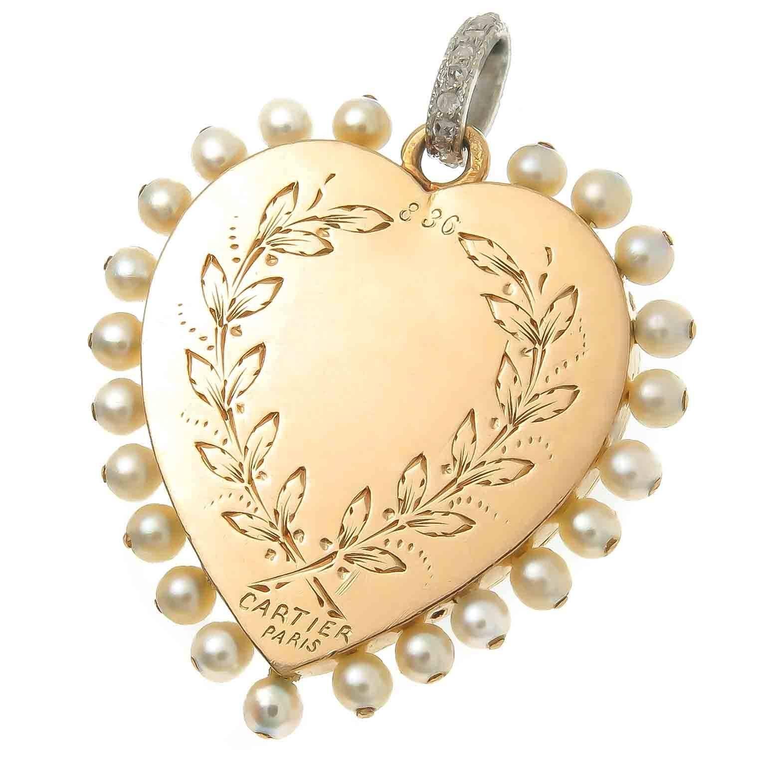 Circa 1910 Cartier Gold and Platinum Heart Pendant in the Belle Epoque style, measuring 1 X 1 inch and being 1/8 inch thick. Finished in a Bright Green Guilloche Enamel and surrounded by White Enamel. Rose cut Diamonds and 2 MM Natural pearls.