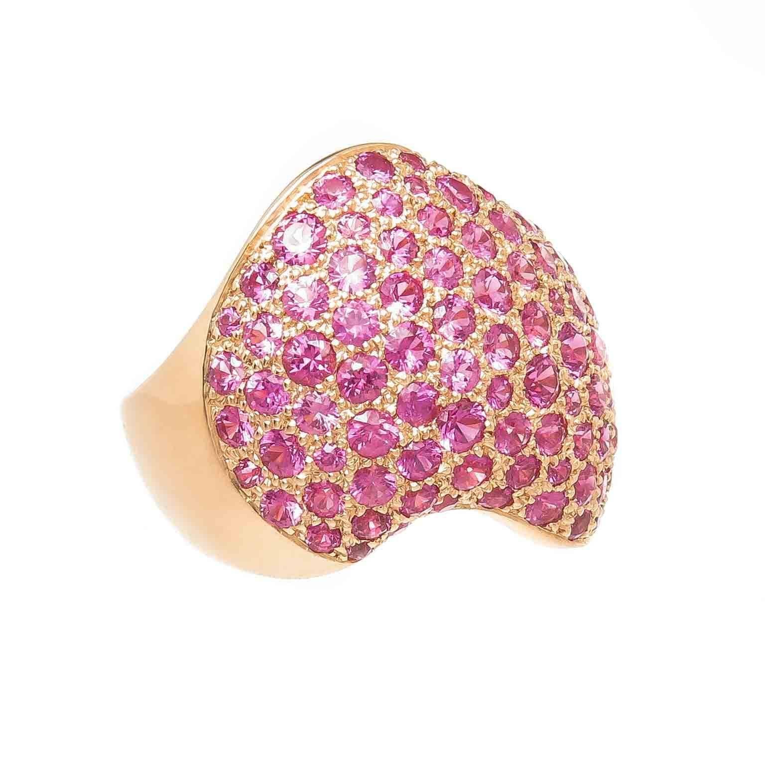 Circa 2005 Van Cleef and Arpels 18k yellow Gold Ring in a wave design and Pave set with Extremely Fine Color Pink Sapphire. The top of the Ring measures 1 inch in length and 1 inch wide. Finger size = 6 1/4. (52 European) Signed, Numbered and in