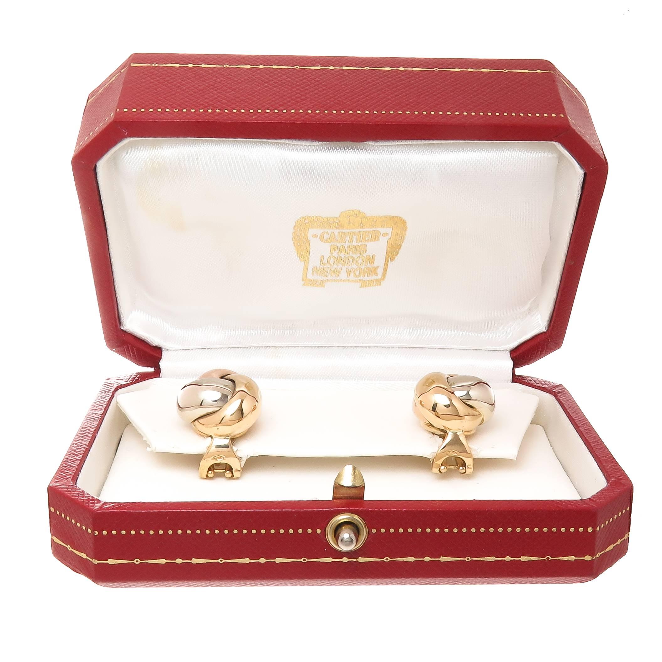 Circa 2005 Cartier Trinity Collection 18K Yellow, Pink and white Gold Tri Color Knot Earrings, measuring 5/8 inch in Diameter and 1/2 inch thick. Having Omega clip backs with a Post. Comes in Original Cartier Presentation Box. 