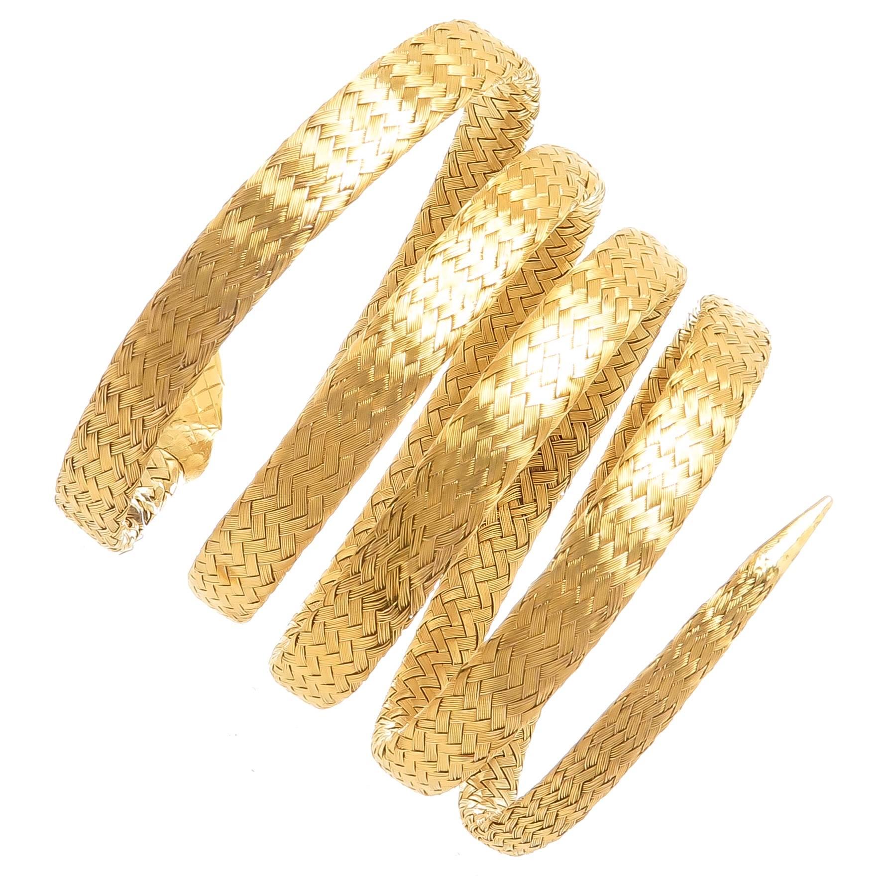 Circa 1910 French 18K Yellow Gold, coiled Snake Bracelet,  woven gold over a piece of light metal for springing, coiling movement. measuring 1.5 inch wide with each section being 1/4 inch. A very detailed Head set with an old Mine Cut Diamond of