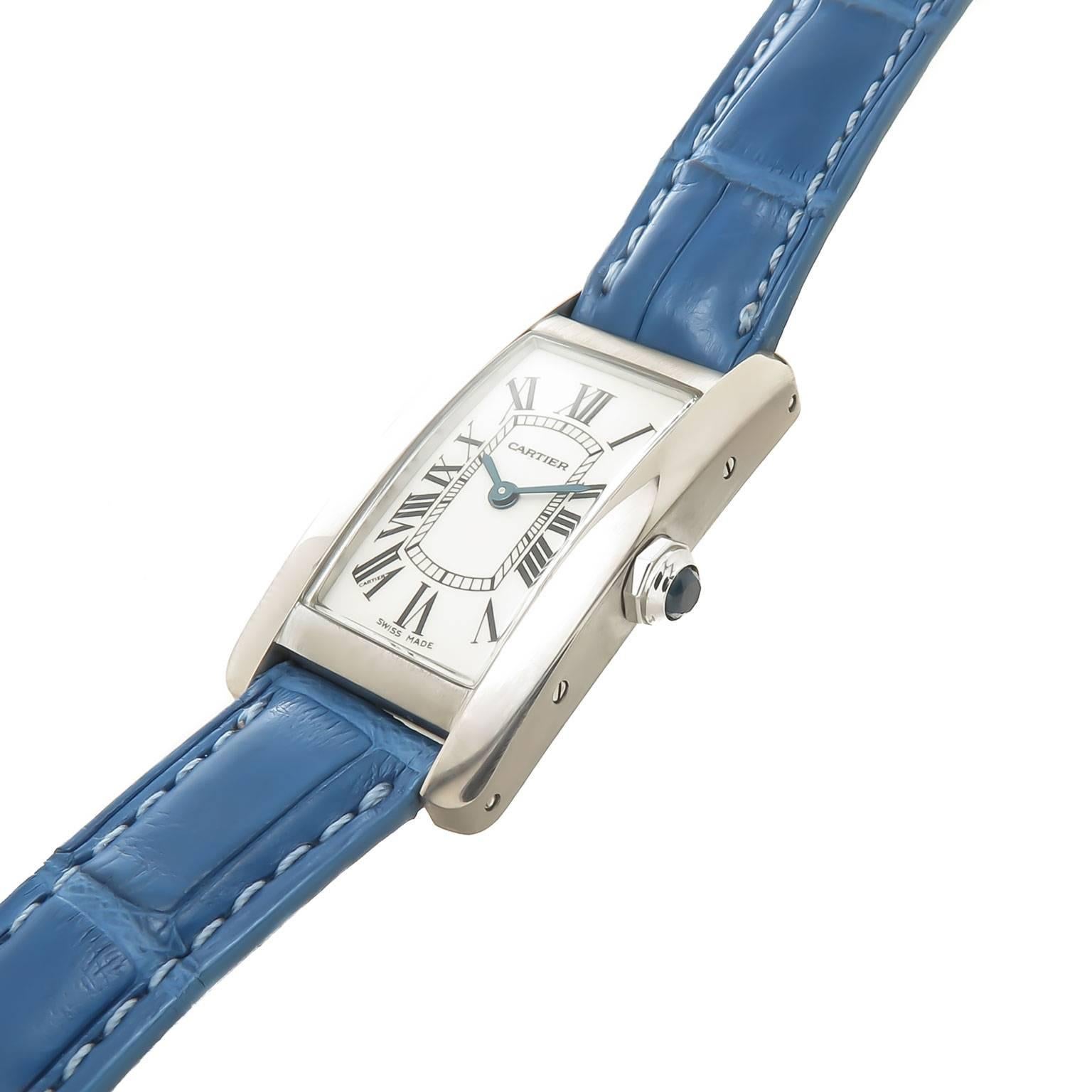 Circa 2000 Cartier Ladies 18K White Gold Tank American Wrist watch. 35 X 19 MM Water Resistant Case, Quartz Movement, Silvered Dial with Black Roman Numerals and a sapphire Crown. Original Cartier Blue Textured Strap with original Cartier 18K