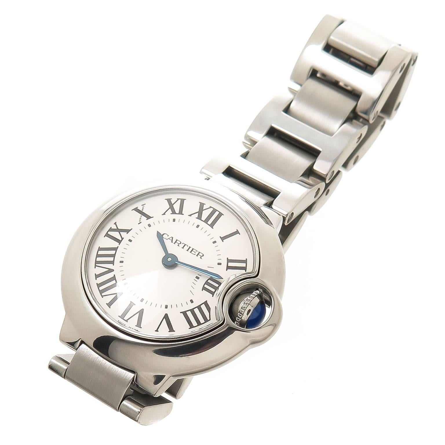 Circa 2014 Cartier Ballon Blue Ladies Wrist watch, 28 MM Stainless steel case, Quartz Movement, Silvered Dial with Black Roman Numerals, scratch resistant crystal and a Sapphire crown. 1/2 inch wide Steel Bracelet with Deployment clasp. Total watch