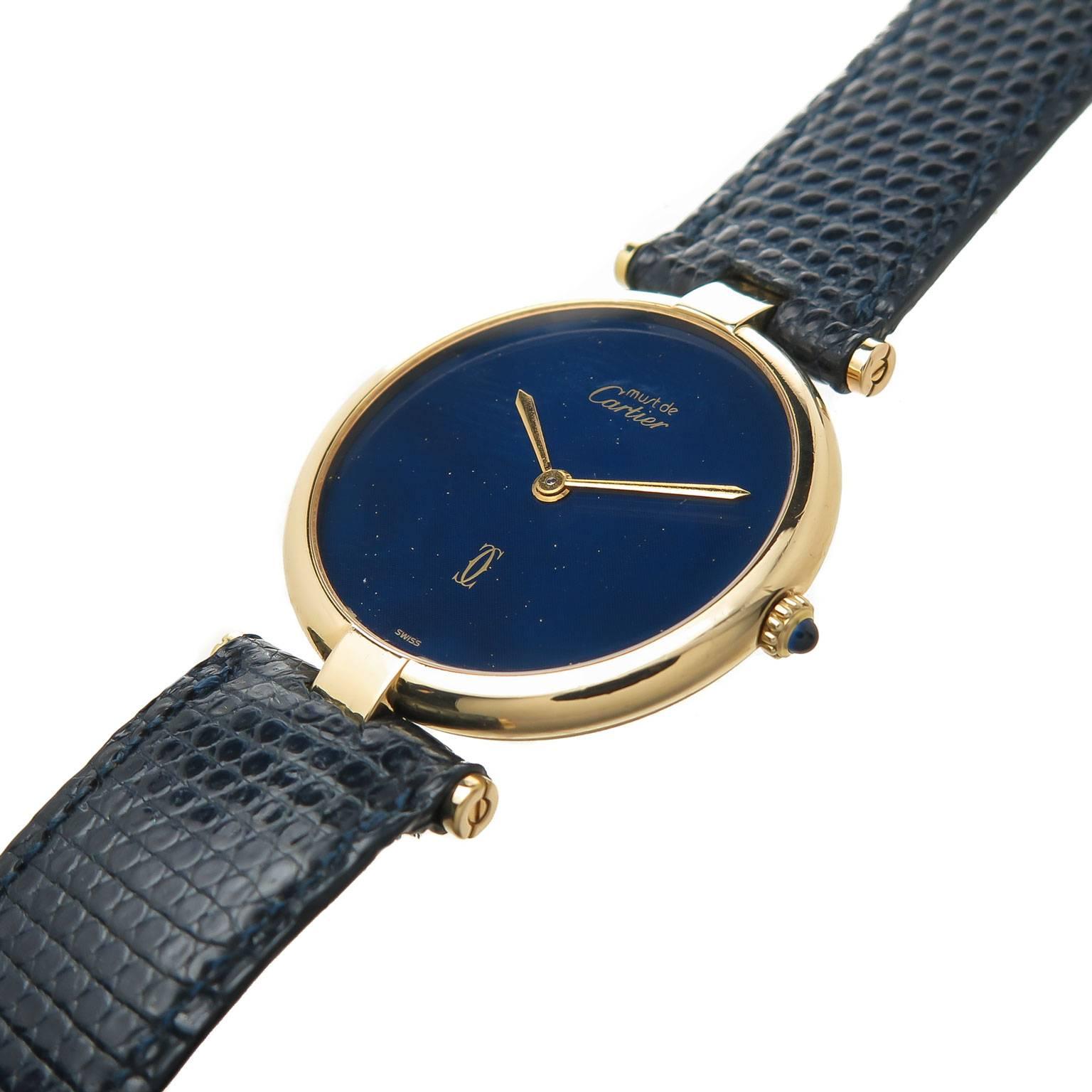 Circa 1990 Cartier Vendome Wrist watch, 30 MM Gold Plate, Sterling Silver ( vermeil ) Case. Quartz Movement, Faux Lapis Lazuli Blue Enamel Dial. Sapphire Crown. Cartier Blue Lizard Strap with Cartier Gold Plate Tang Buckle. Comes in a Cartier Suede