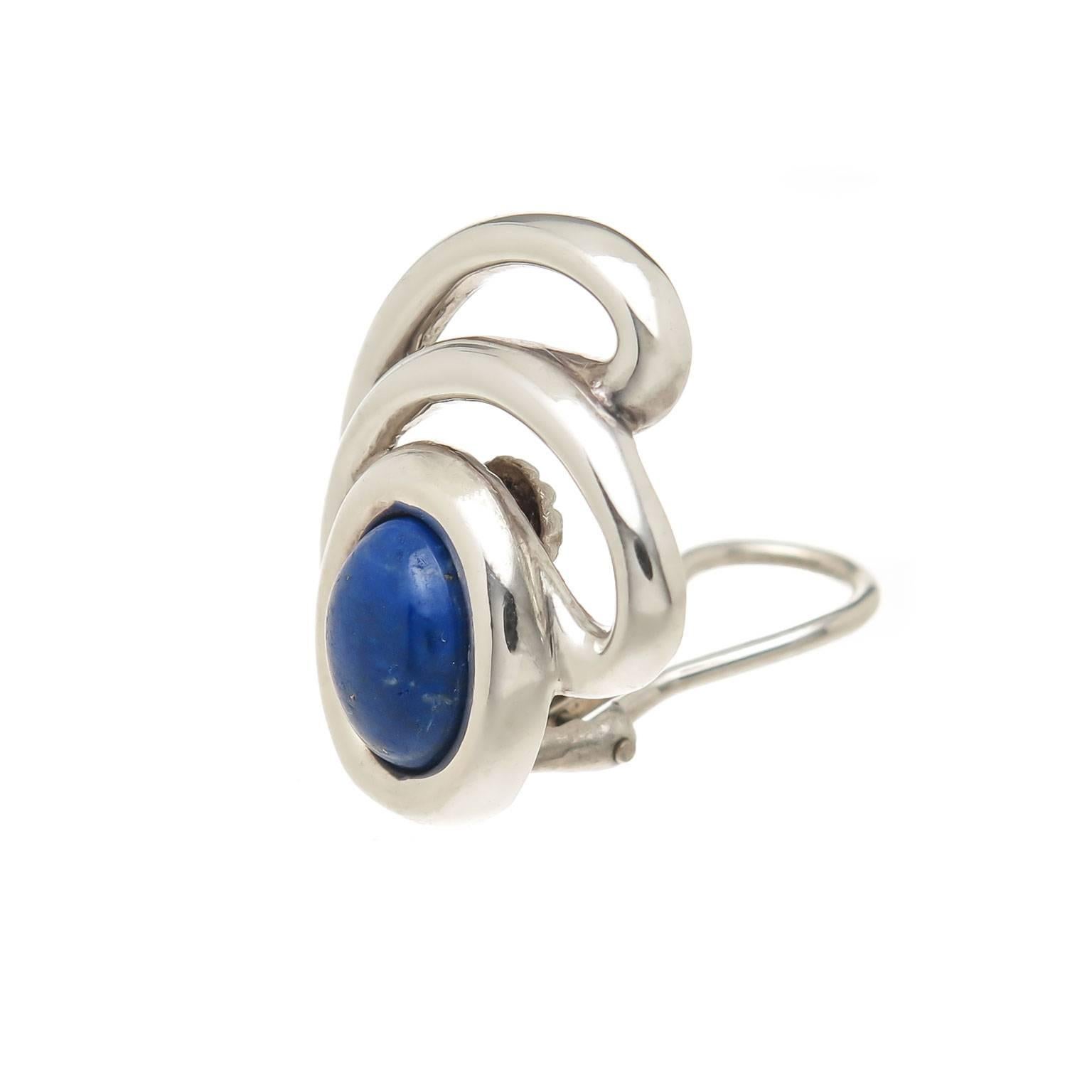 Circa 1980s Tiffany & Company Sterling Silver and Lapis Lazuli Earrings, measuring 1 inch in length X 3/4 inch. Set with an Oval Fine Color Lapis Lazuli, Omega clip backs to which a post can be easily added if desired. 