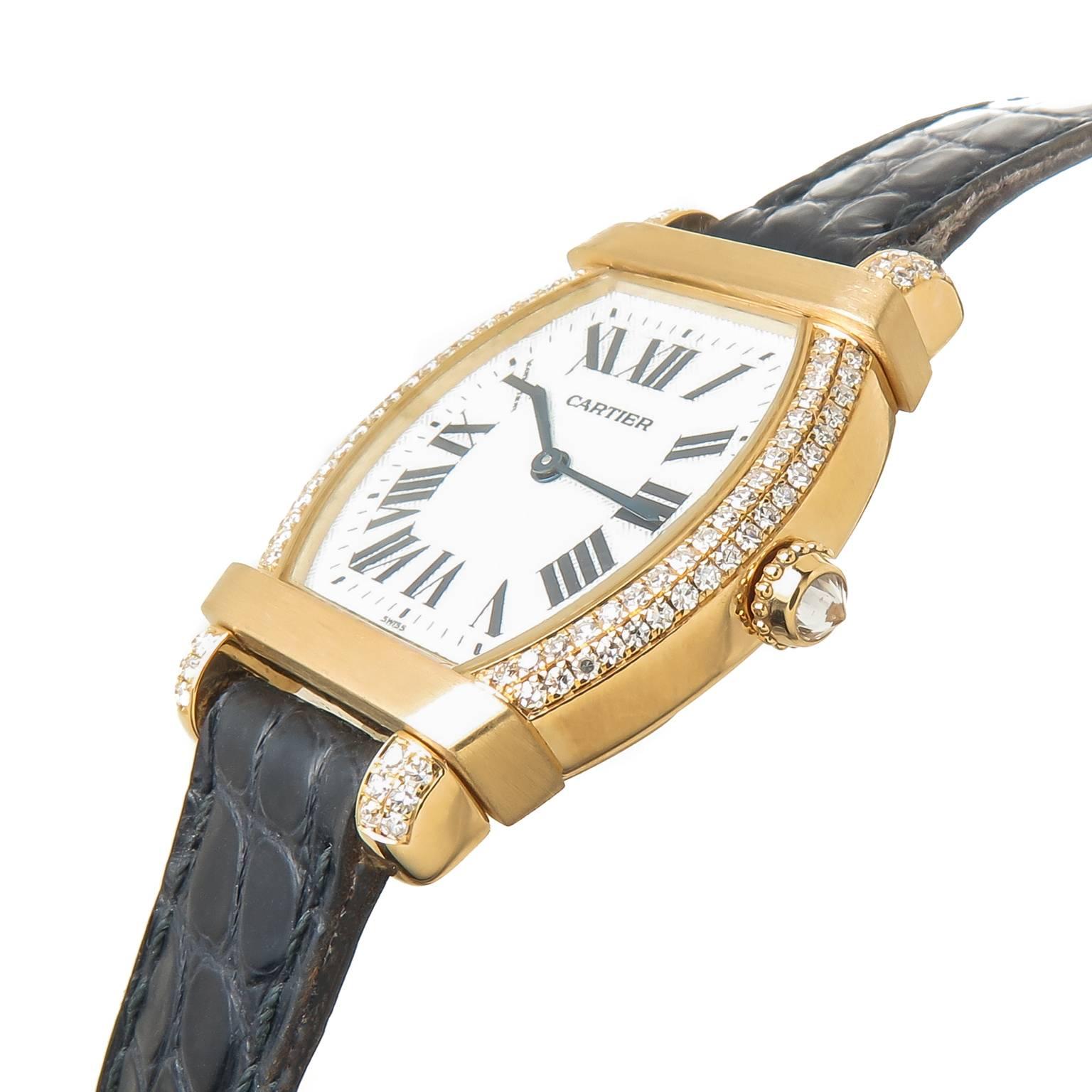 Circa 2010 Cartier Tortue Chinoise Ladies Wrist Watch, 34 X 26 MM water resistant case. Factory set double row Diamond Case totaling 1.50 Carats. Quartz Movement. Mother of Pearl dial with Black roman numerals, Diamond set crown. Original Black