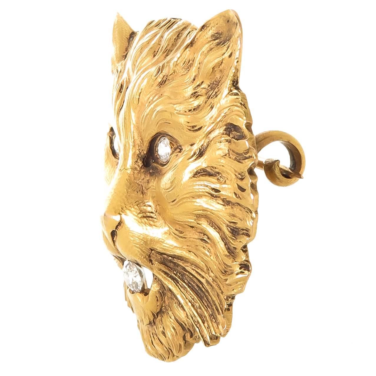 Circa 1910 18K yellow Gold Cat brooch, measuring 1 3/4 X 1 5/8 inch and weighing 33.5 Grams. The piece is finely finished with hand chased workmanship and set with Old Mine cut Diamonds totaling .35 Carat. 