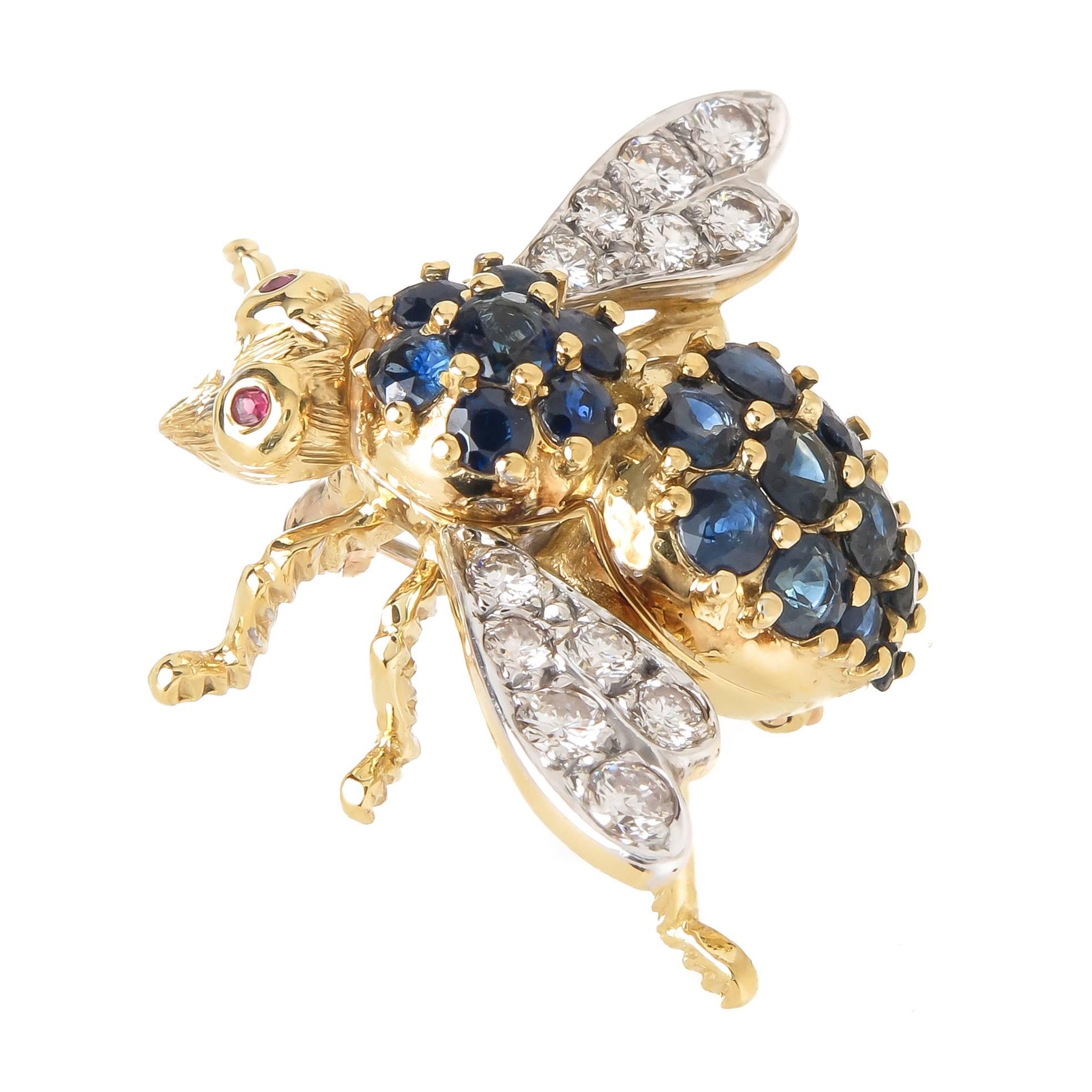 Circa 1980s Herbert Rosenthal 18K yellow Gold Bee Brooch, measuring 1 inch in length and 1 1/4 inch wing tip to tip, set with Fine White round Brilliant cut Diamonds totaling .75 Carat and further set with Sapphires and Rubies for the Eyes. 