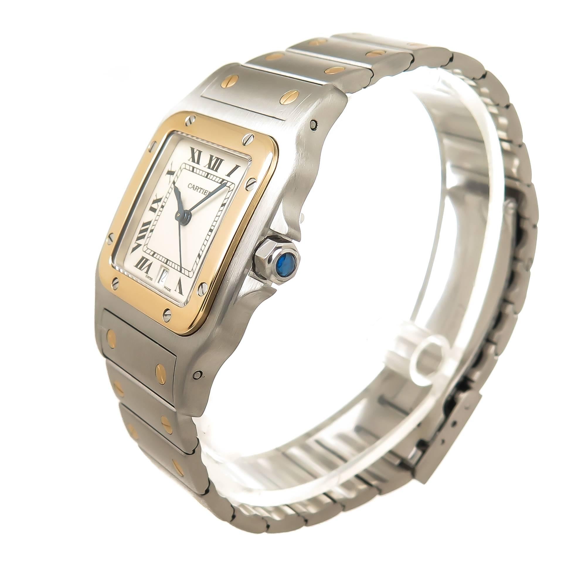 Circa 2000 Cartier Santos Gents Wrist watch, 41 X 30 MM Stainless Steel case with 18k Yellow Gold Bezel, quartz movement, White Dial with Black roman Numerals, sweep seconds hand, calendar window at the 6 position and a sapphire crown. 3/4 inch wide