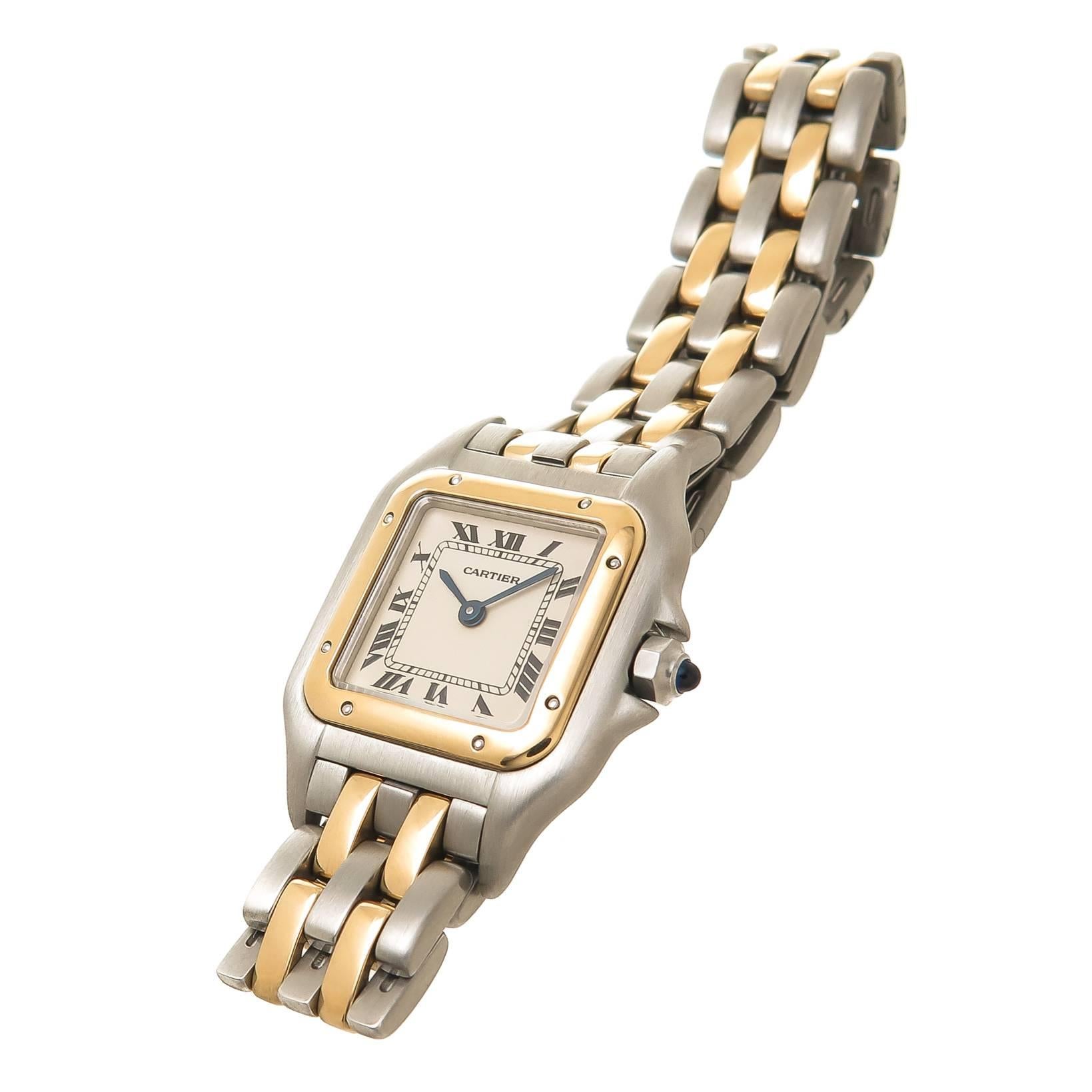 Circa 1990s Cartier Ladies Panther Collection Ladies Watch, 30 X 23 MM Stainless Steel Water resistant Case with 18K yellow Gold Bezel, Quartz Movement, White Dial with Black Roman Numerals and a sapphire Crown. 1/2 inch wide 