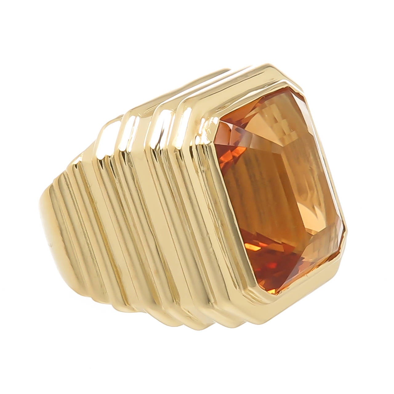 Circa 2005 Large 18K yellow Gold Ring with a deep ribbed design by Marlene Stowe, set with a Golden Honey color stepped cut Citrine of approximately  15 Carats. The ring measures 3/4  X  3/4 inch across the topFinger size = 7