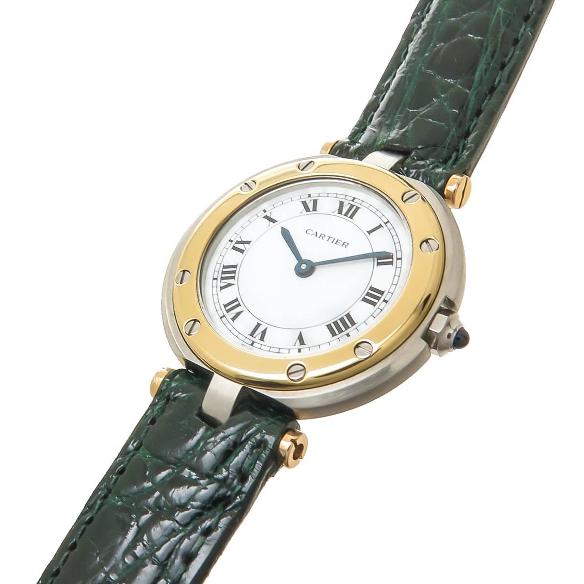 Circa 1980s Cartier Santos Ronde Ladies wrist watch, 27 MM Stainless Steel case with an 18K yellow Gold Bezel and Lug End pieces. Quartz Movement, White Dial with Black roman Numerals, sapphire set Crown. New Hadley Roma dark Green Crocodile Strap.