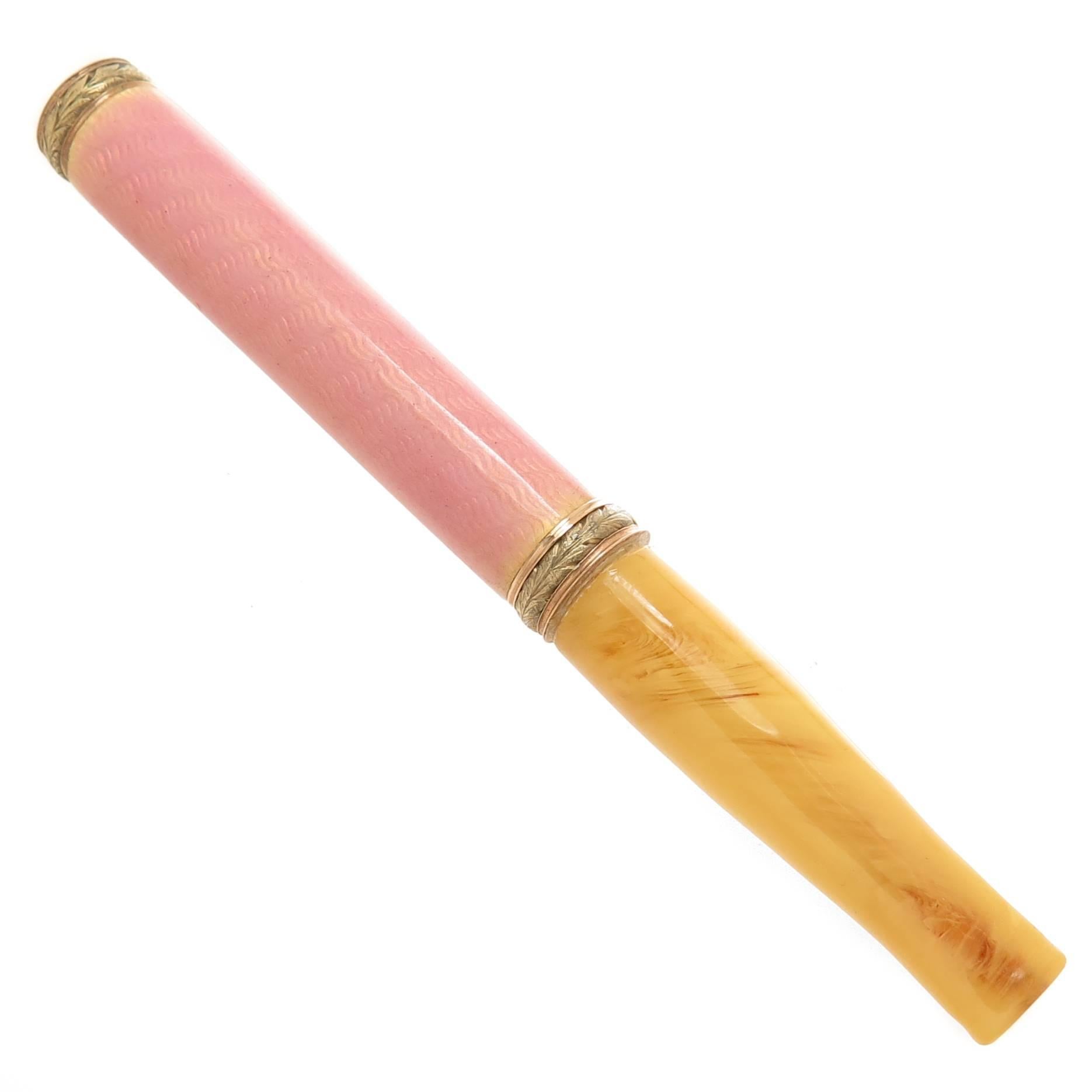 Circa 1900 Faberge Rose and Green Gold Cigarette Holder, measuring 3 1/2 inch in length and 3/8 inch thick, the central section is finished in Pink Guilloche enamel and the Mouth Piece appears to be Amber.  The piece is stamped with work master