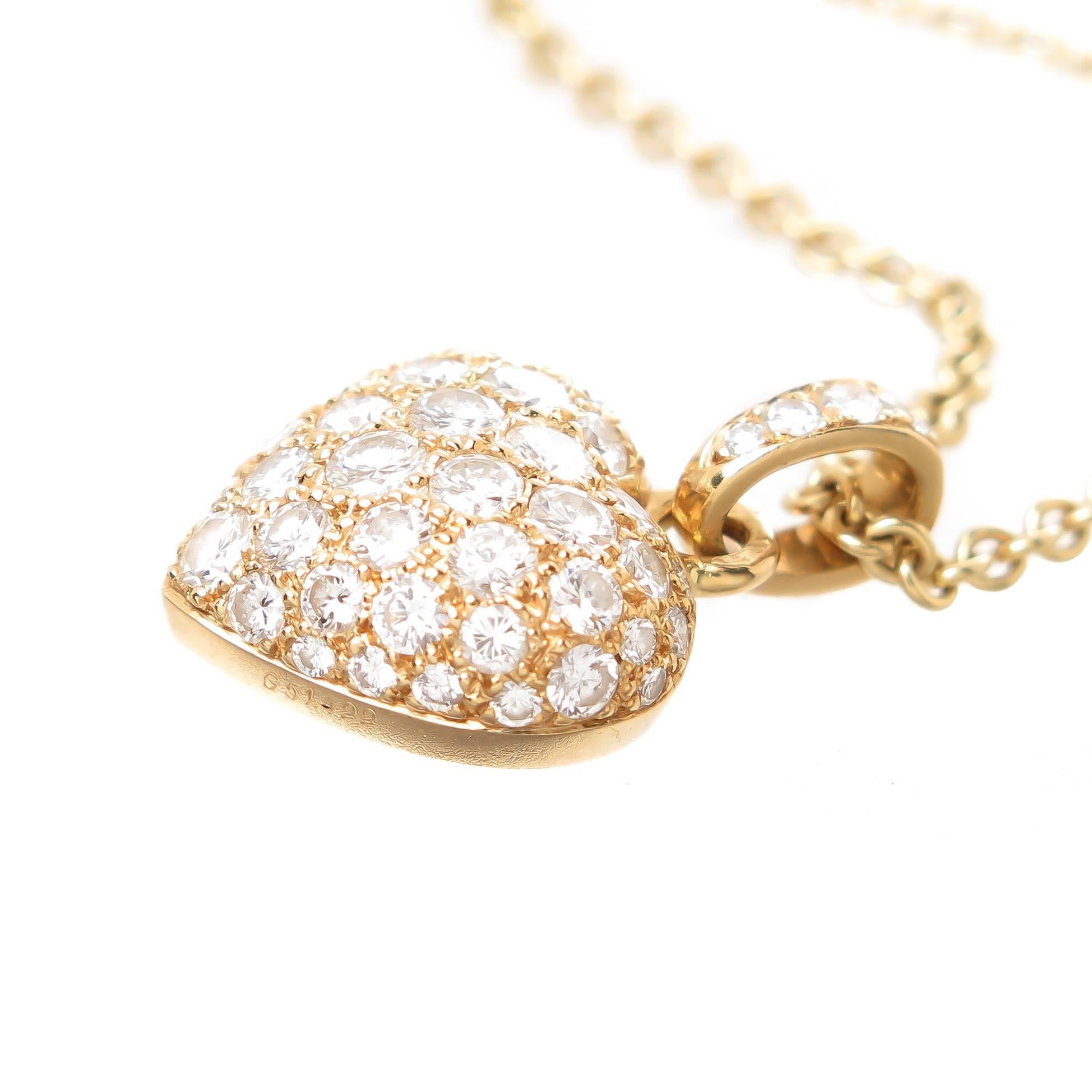 Circa 2010 Cartier Heart Pendant 18K yellow Gold and measuring 3/4 X 1/2 inch, set with very fine White Round brilliant cut Diamonds totaling approximately 1.40 carats. Suspended from a Cartier 18k yellow Gold link chain measuring 17 inch and is