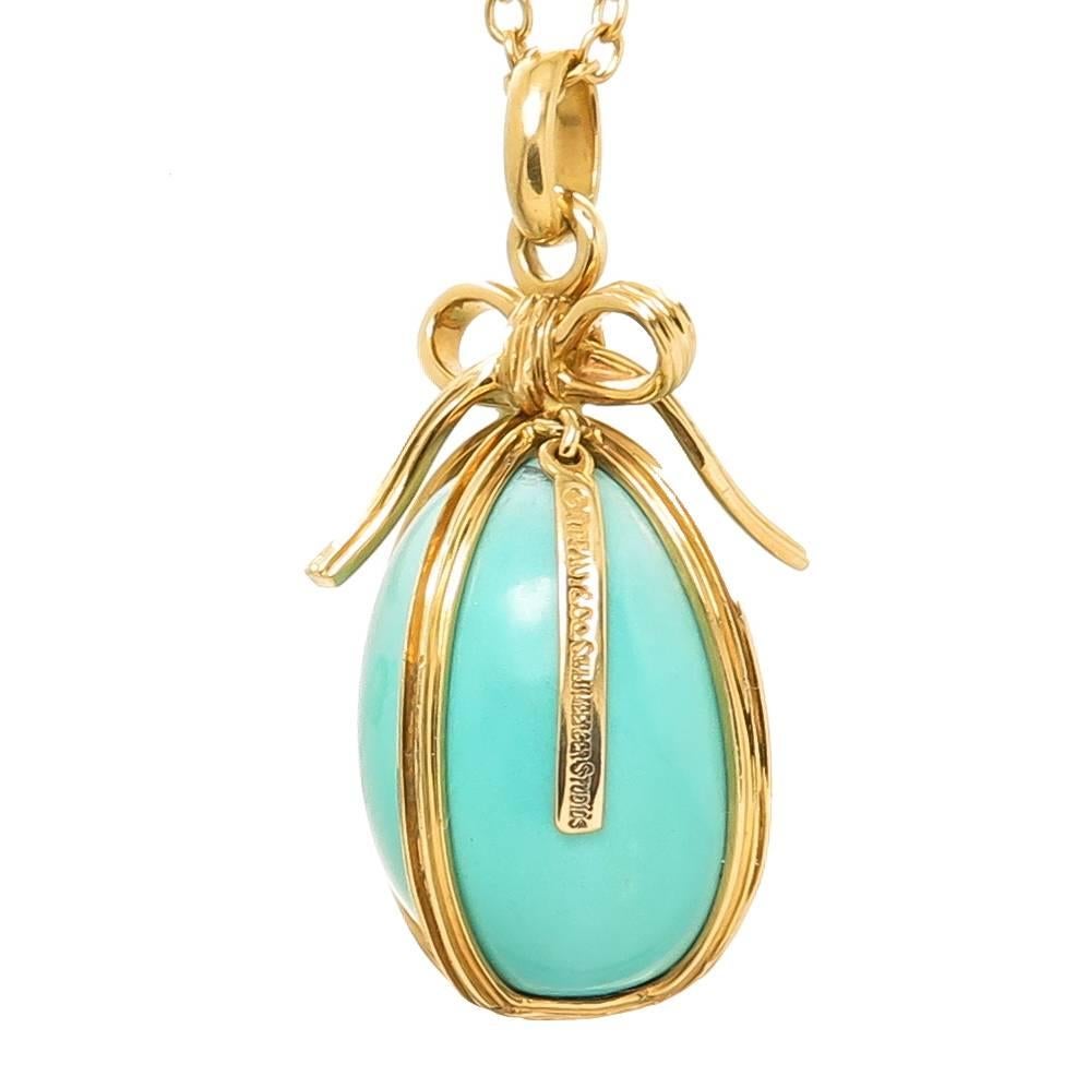 Circa 1980s Jean Schlumberger for Tiffany & Company Egg Pendant, Persian Turquoise Egg in an 18K Yellow Gold Frame, measuring 1 1/4 inch in height and 3/4 inch wide, suspended from an 18K Tiffany Chain measuring 30 inch in length. Excellent