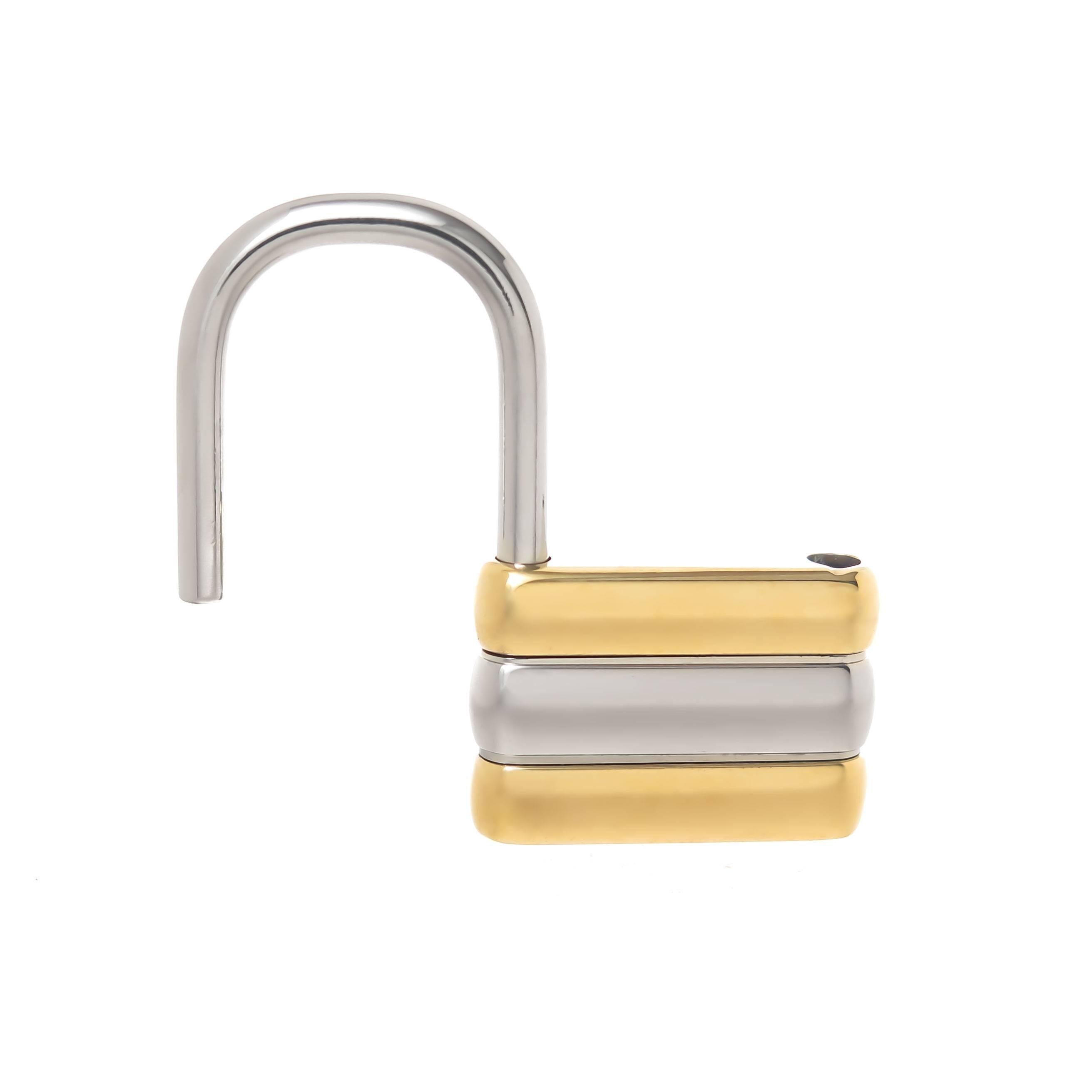 Circa 1970s Cartier Lock form Key Holder, measuring 2 inch  X 1 1/4 inch, Bright polish white metal and Gold plate.