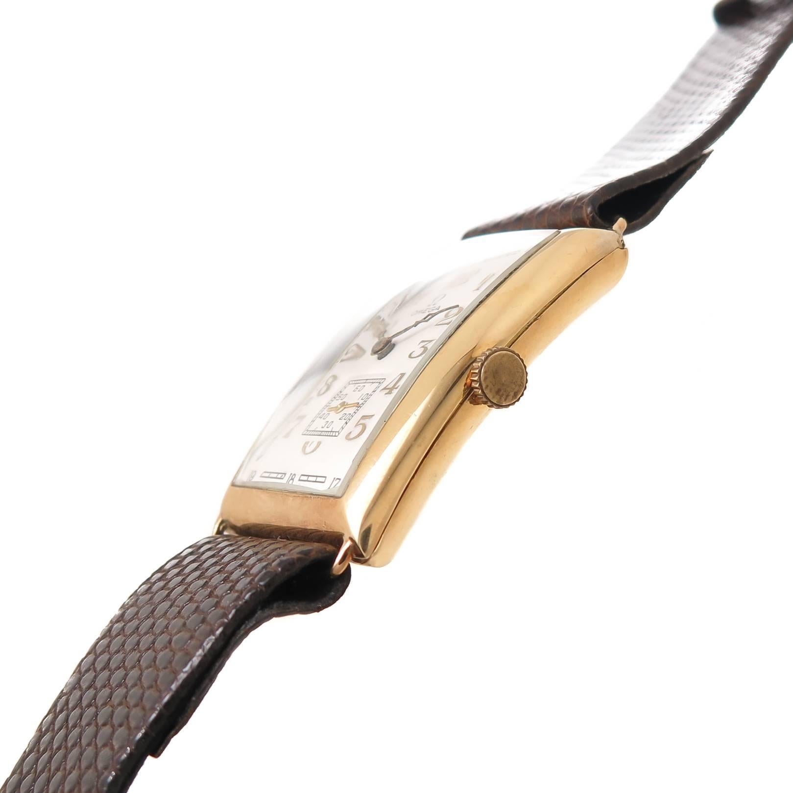 Circa 1930 Omega oversize Wrist watch, 18K yellow Gold signed Omega case with a slight curve measuring 35 X 26 MM. Mechanical, manual wind 17 Jewel movement, original white dial with raised gold markers. Hirsch Brown Lizard strap, total watch length