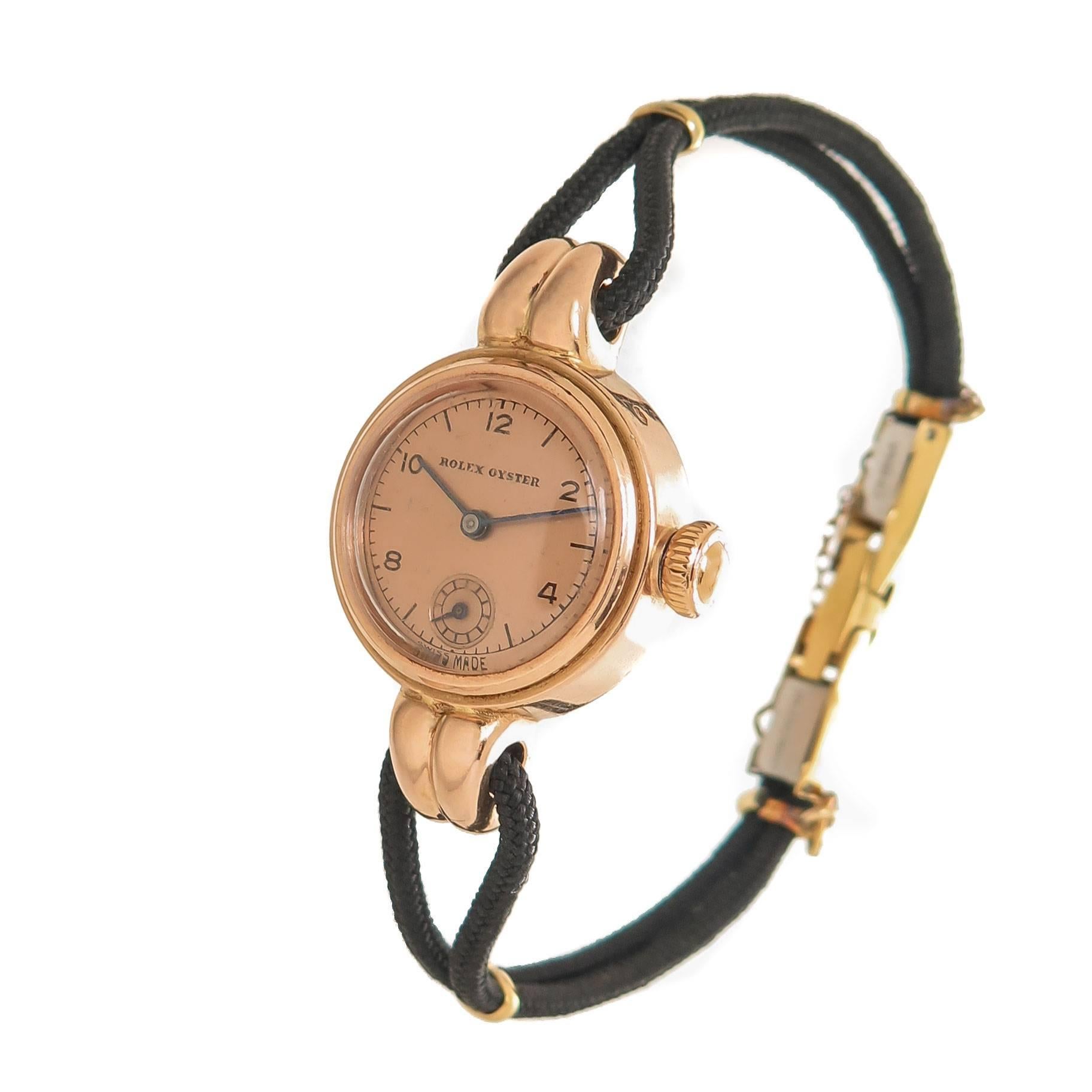 Circa 1940s Rolex 14K Rose Gold Ladies Wrist watch, 21 MM Diameter and 7 MM thick 2 piece Oyster Case. 17 Jewel Mechanical, Manual wind movement. Original Rose Gold Rolex Screw down Crown and original Rose Dial with sub seconds chapter. New Black
