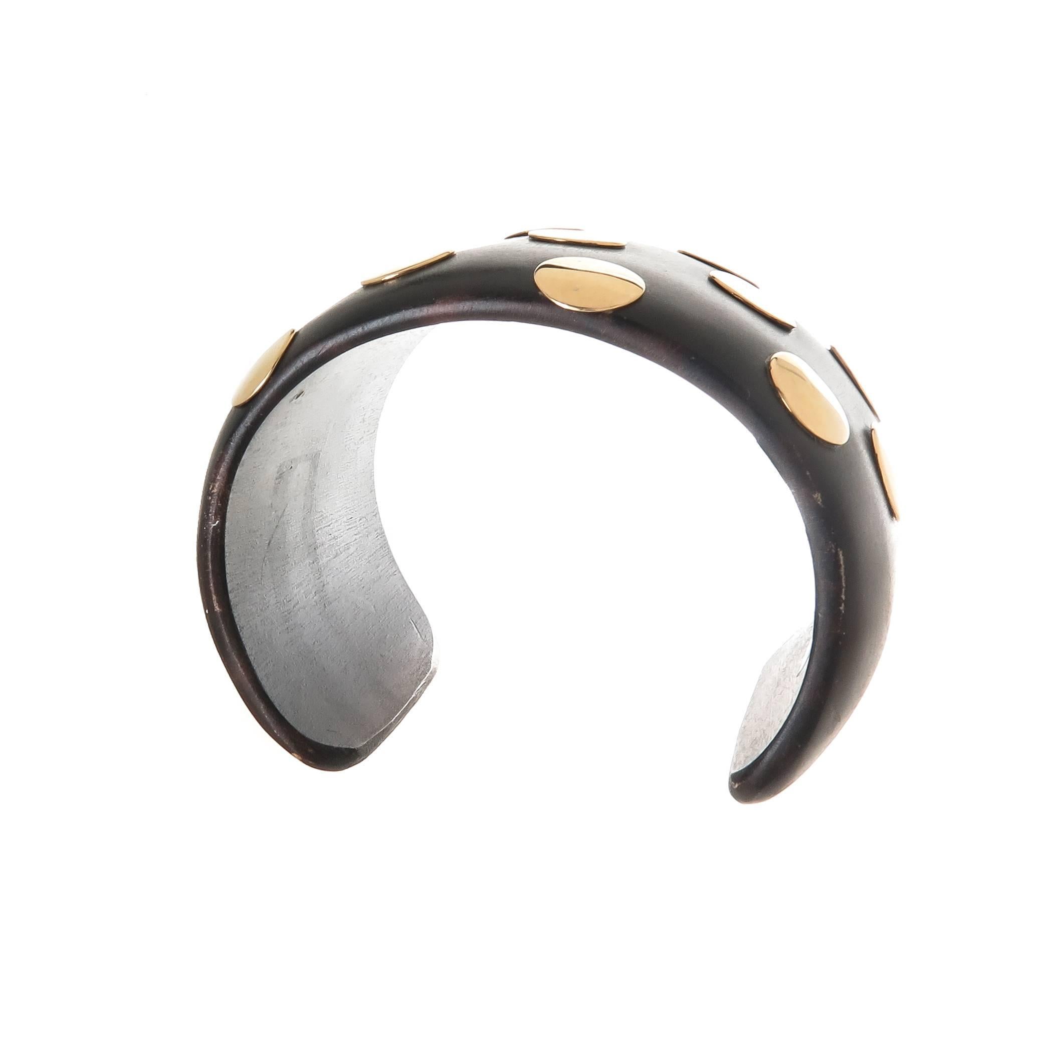 Circa 2000 Wood and 14K yellow Gold Dots mounted cuff bracelet, measuring 1 5/8 inch wide with an inside measurement of 6 inch an a 1 1/2 inch wide opening. 