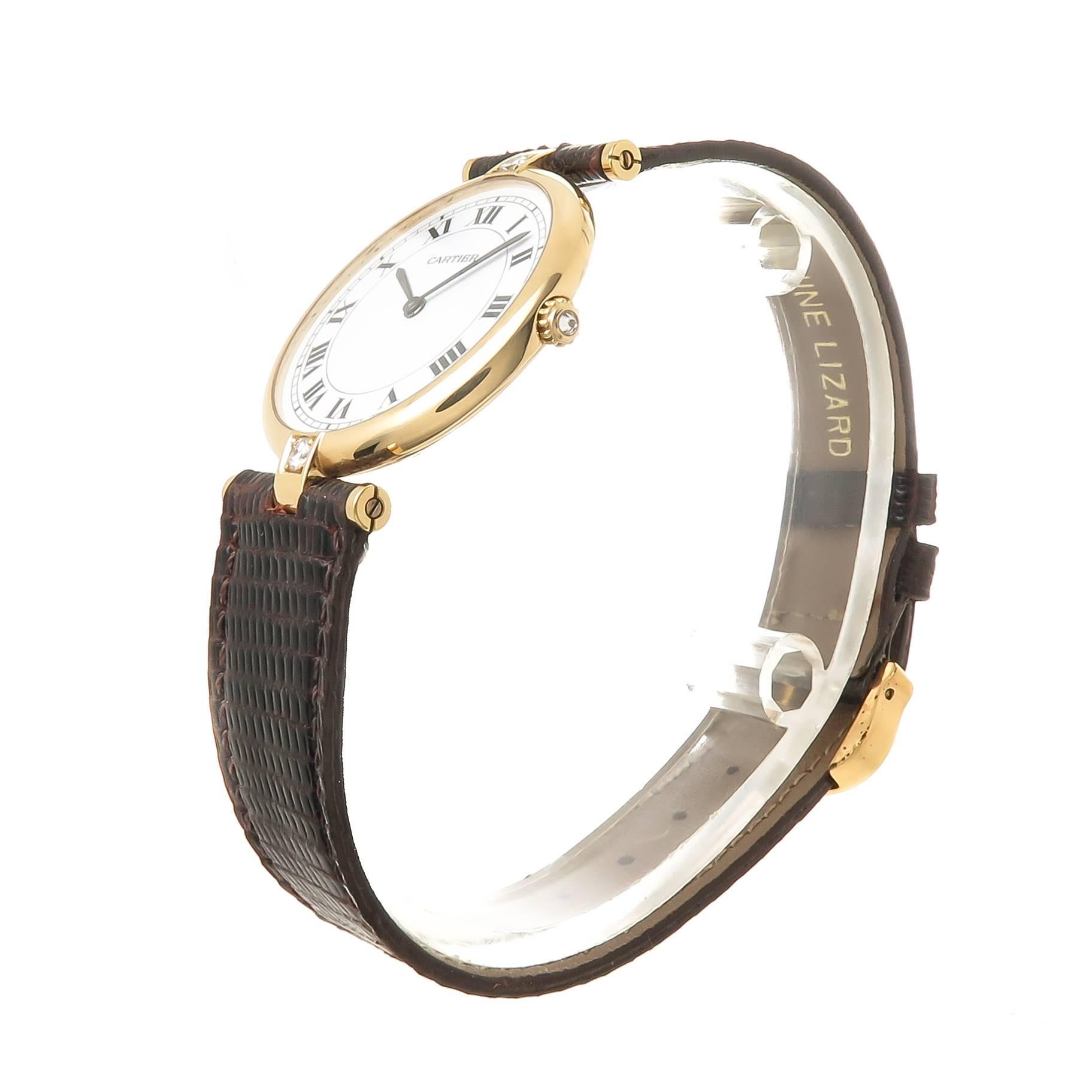 Circa 2000 Cartier Vendome Collection Wrist Watch, 30 MM 18K Yellow Gold and set with a Diamond at each end of the case as well as a Diamond set in the crown. Quartz Movement, White Dial with Black Roman Numerals.  New brown Lizard strap with