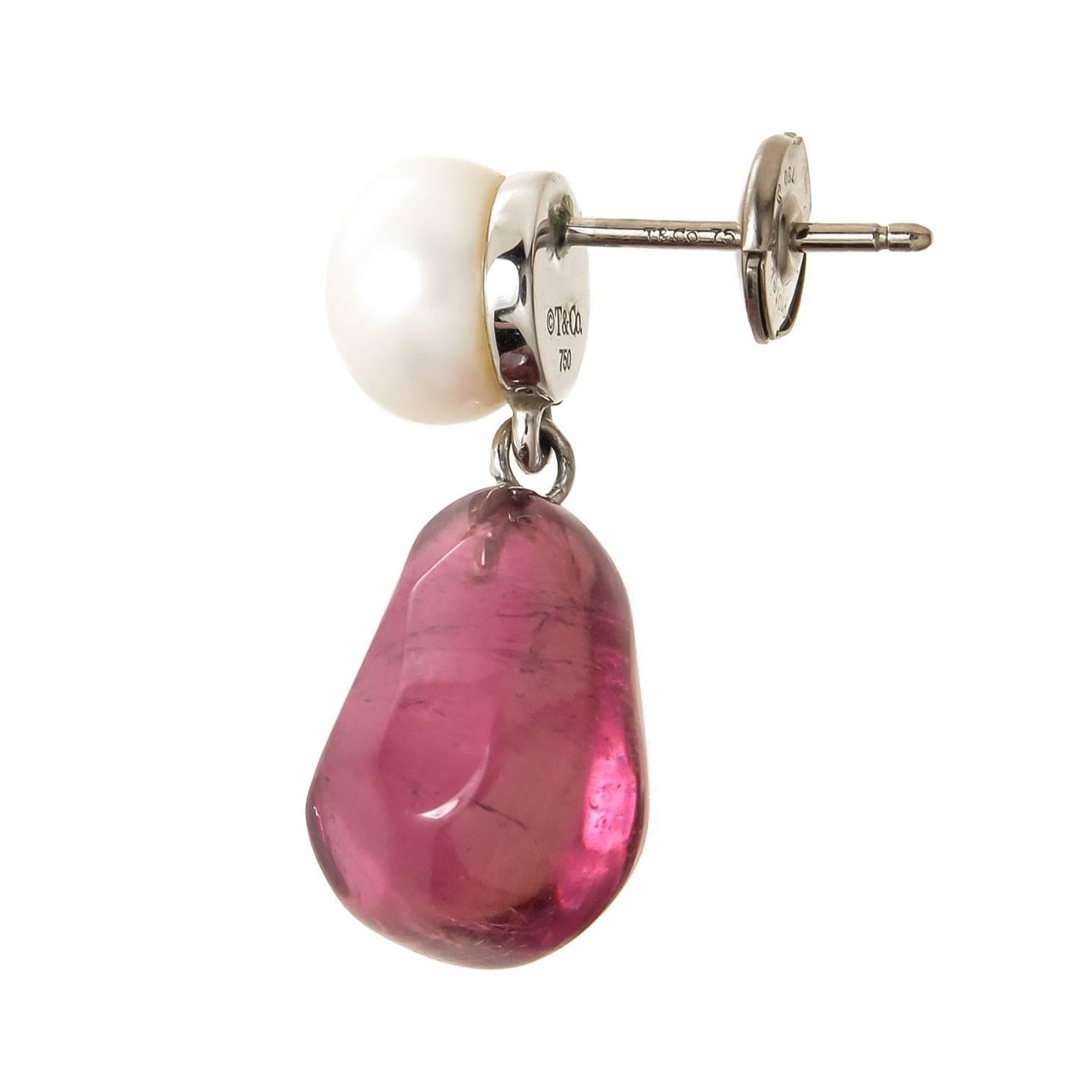 Circa 2005 Tiffany & Company 18K White gold Earrings set with a Fine Color Tumble, Polished Pink Tourmaline's with an 8 MM Button pearl set at the top. The earrings measure 1 inch in length with the Tourmaline's each measuring 14 X 11 MM.