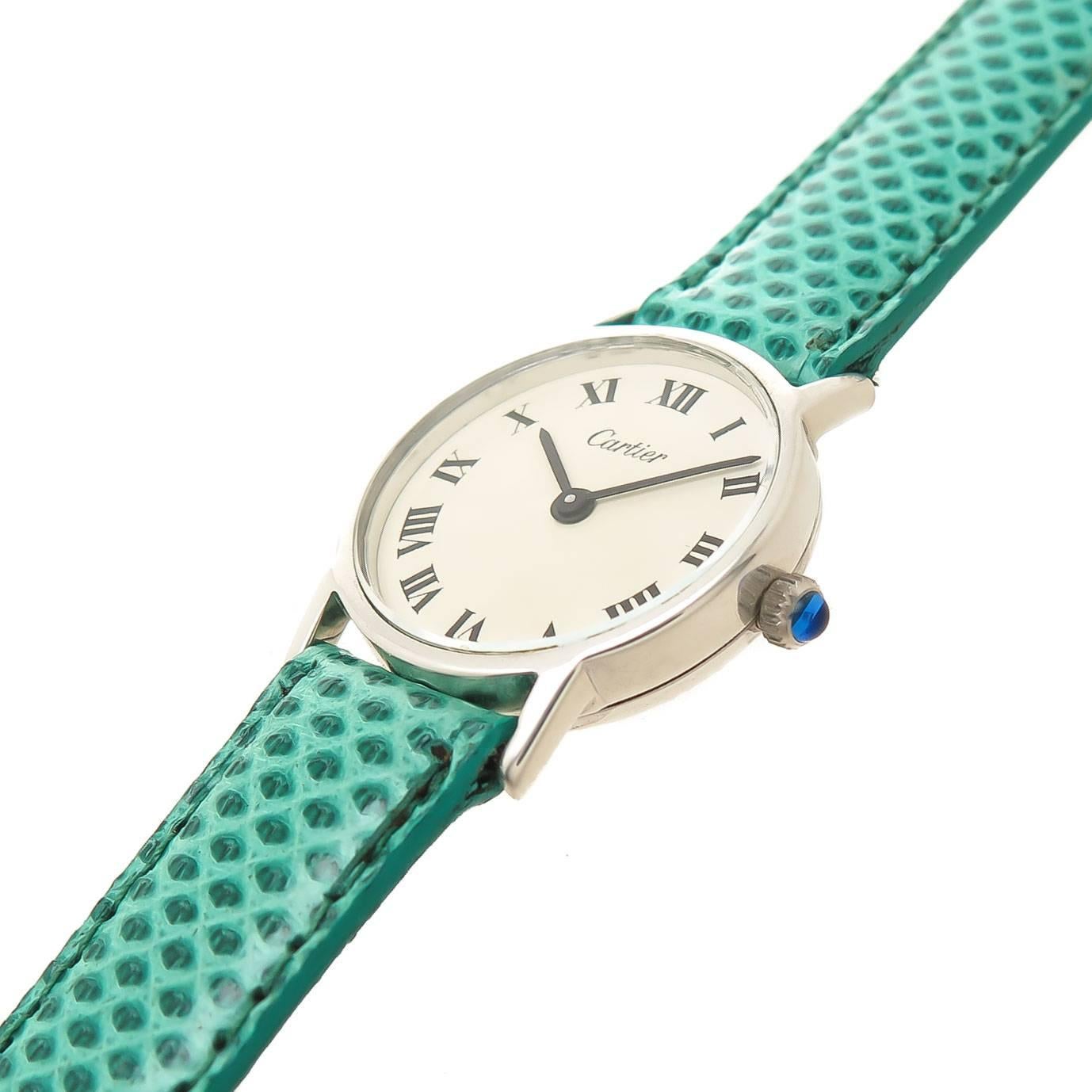 Circa 1970s Cartier Ladies Wrist watch, 24 MM Sterling Silver 2 piece Case. 17 Jewel Cartier Inc. mechanical, Manual wind Movement. White Dial with Black Roman Numerals and a Sapphire Crown. New Hadley Roma Green reptile Strap with Cartier Tang