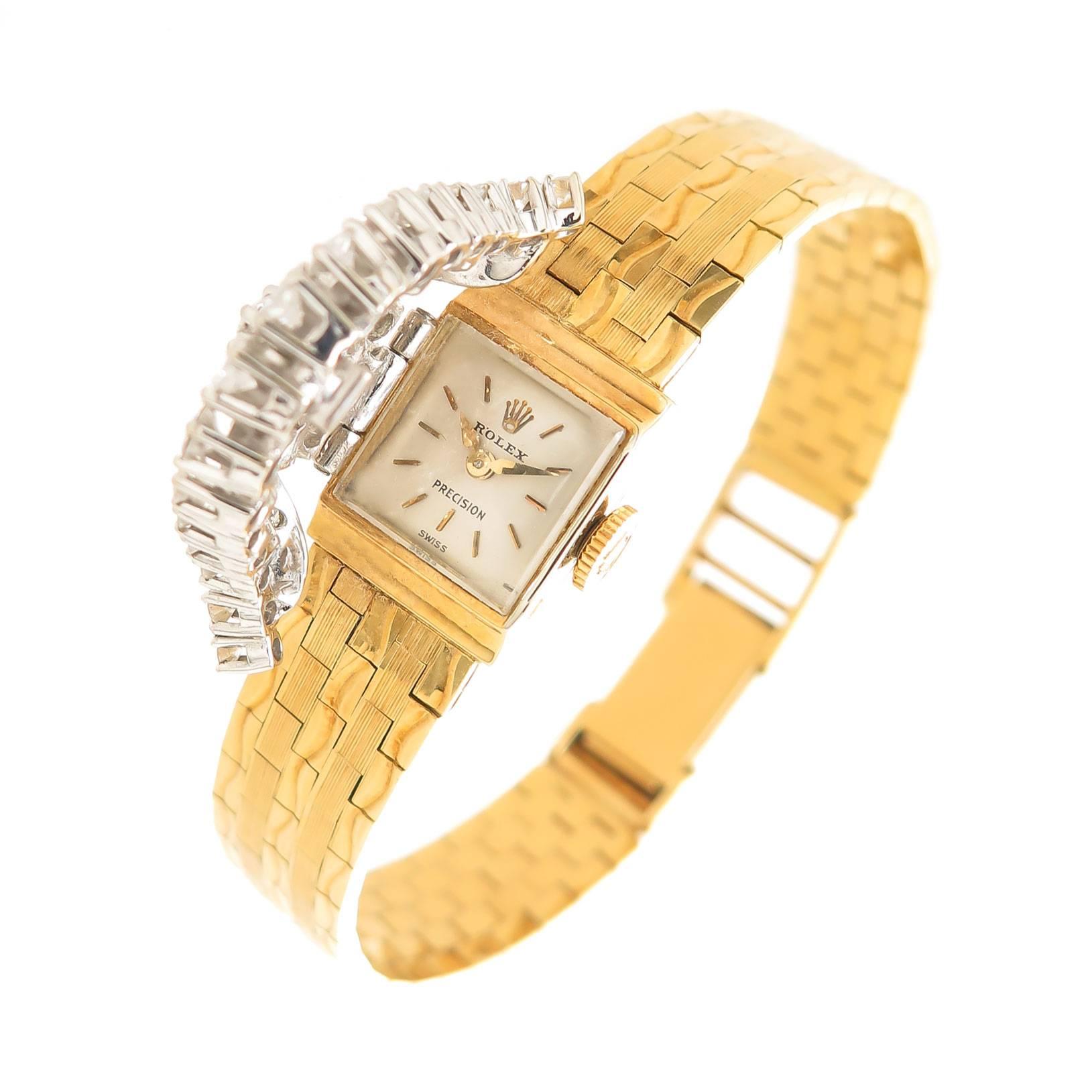 Circa 1960s Rolex ladies Covered Bracelet Watch, 18K Yellow Gold Signed Rolex Case with a White Gold Hinged Cover set with Fine color Round Brilliant cut Diamonds Totaling 1.25 Carats. 17 Jewel mechanical, manual Wind Movement, Original white dial