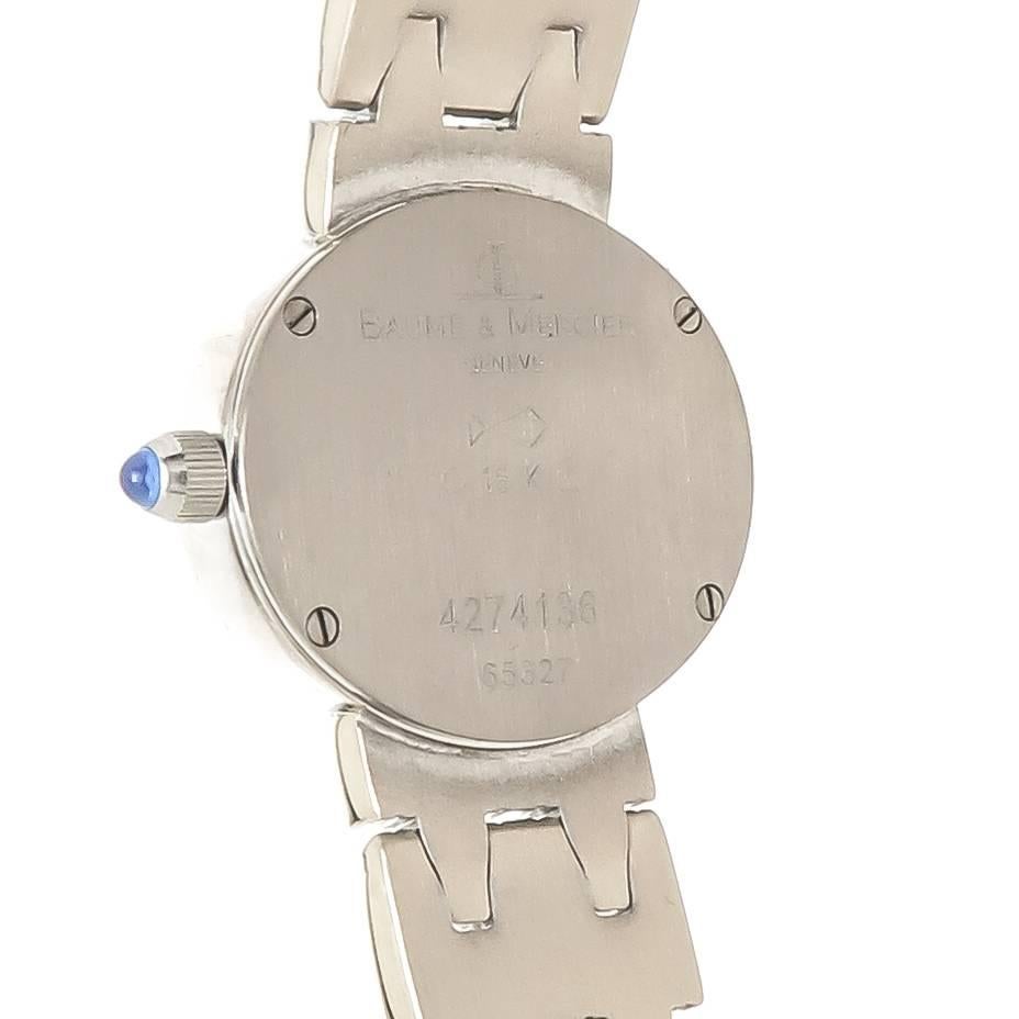 Circa 2010 Baume & Mercier 18K White Gold Ladies Bracelet Wrist watch, 22 X 18 MM Oval 2 piece case, Quartz movement, Mother of Pearl Dial with Diamond set markers and a Diamond set bezel totaling approximately 1/2 carat of Fine White Round