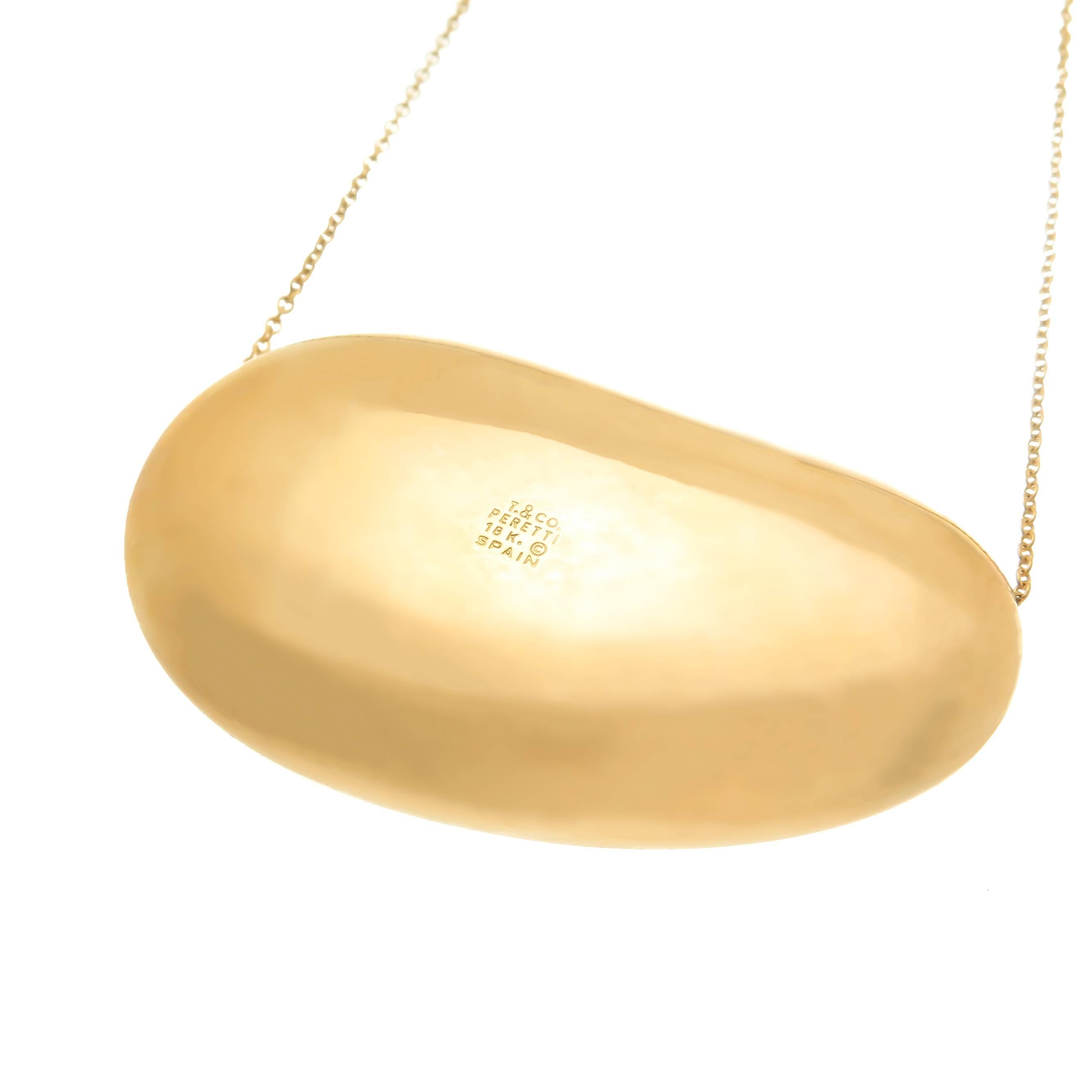 Circa 1990s Elsa Peretti for Tiffany & Company, this is the largest of the 18K yellow Gold Bean collection pendants and the hardest to find, measuring 2 inches in length X 1 inch and 1/2 inch wide.  Suspended from a 30 inch Tiffany Chain.  Comes in