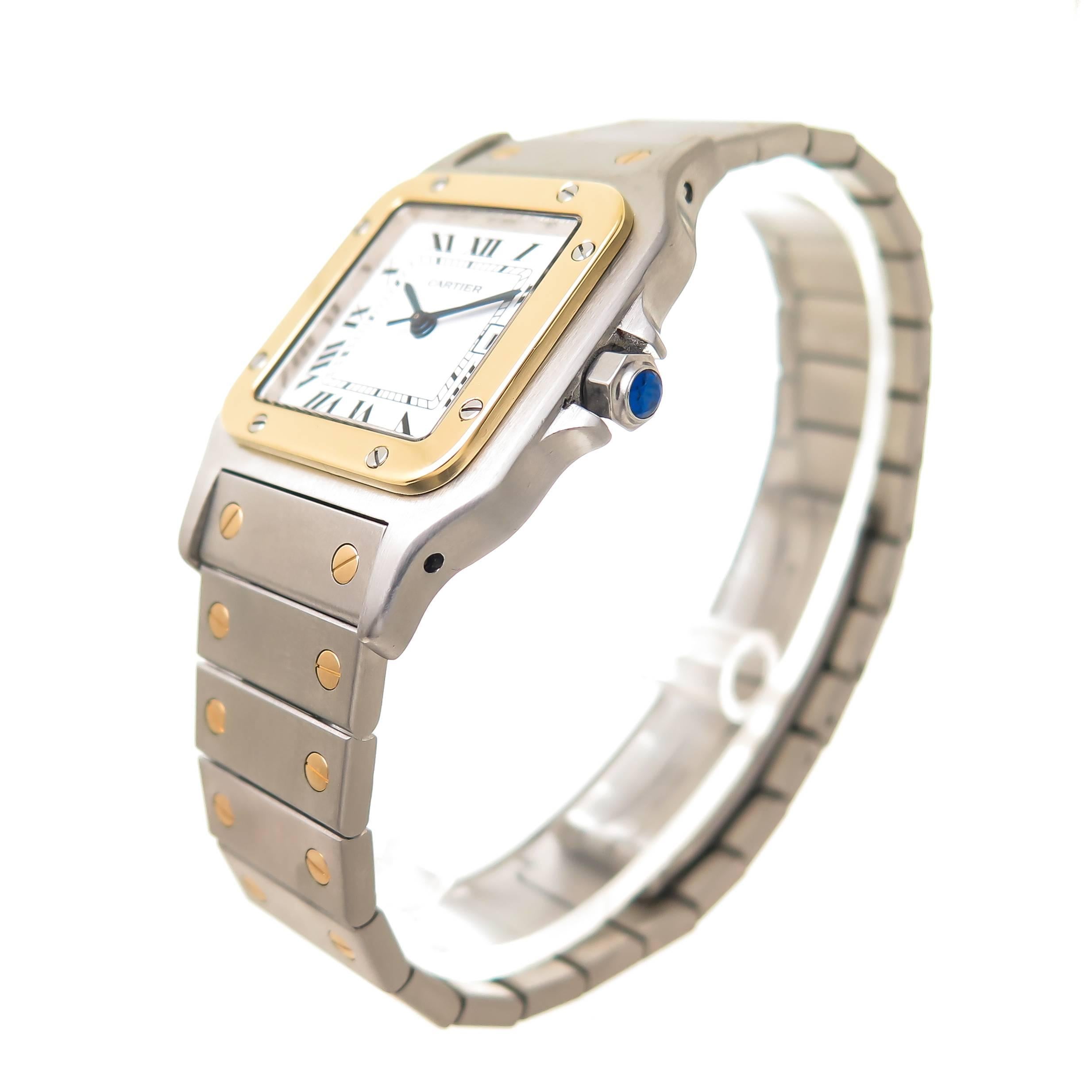 Circa 2000 Cartier Santos Wrist watch, 41 X 30 MM Water resistant Stainless Steel case with 18k Yellow Gold Bezel, Automatic, self winding movement, White Dial with Black roman Numerals, sweep seconds hand, calendar window at the 3 position and a