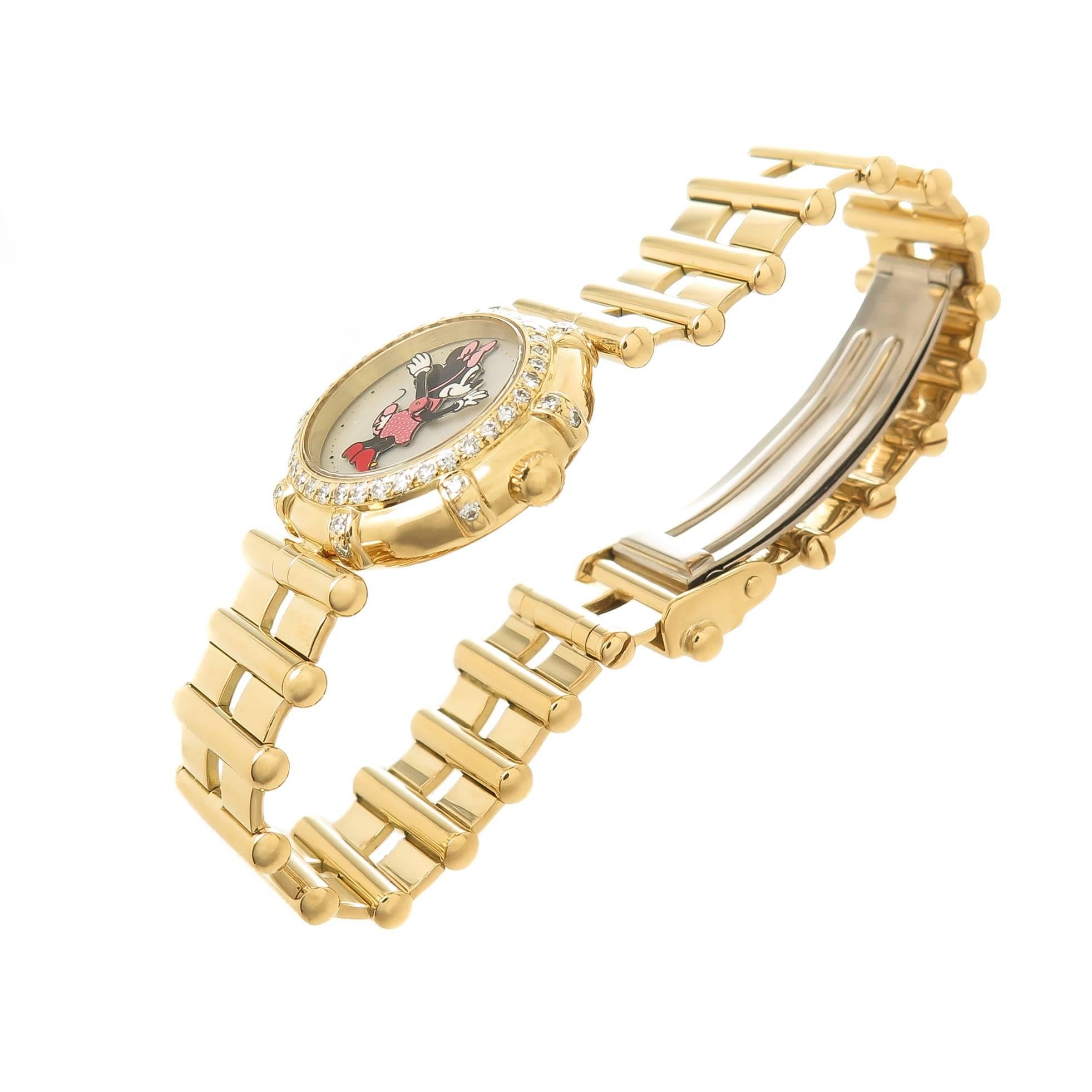 Circa 1990s Gerald Genta 18K yellow Gold Minnie Mouse Wrist watch, measuring 23 MM in Diameter, Diamond Bezel set with Round Brilliant Cuts totaling 1 carat and Grading as F-G in color and VS in clarity. Quartz Movement, White Mother of Pearl dial