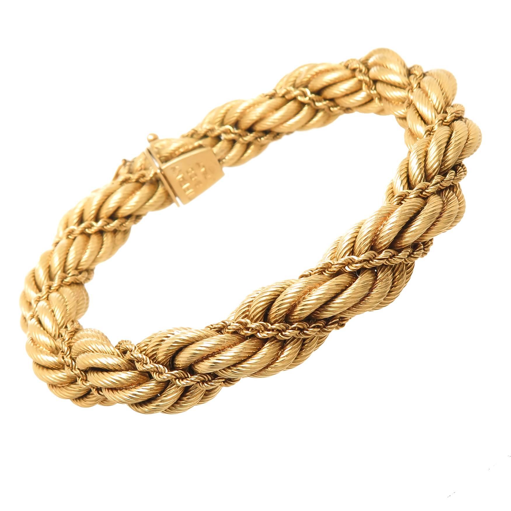Circa 1970s Tiffany & Company very elegant 18k yellow Gold Rope Bracelet with a smaller Rope bracelet intertwined. measuring 7 3/4 inches in length, 7/16 inch wide and weighing 40.3 Grams. Excellent, near unworn condition and comes in a Tiffany felt