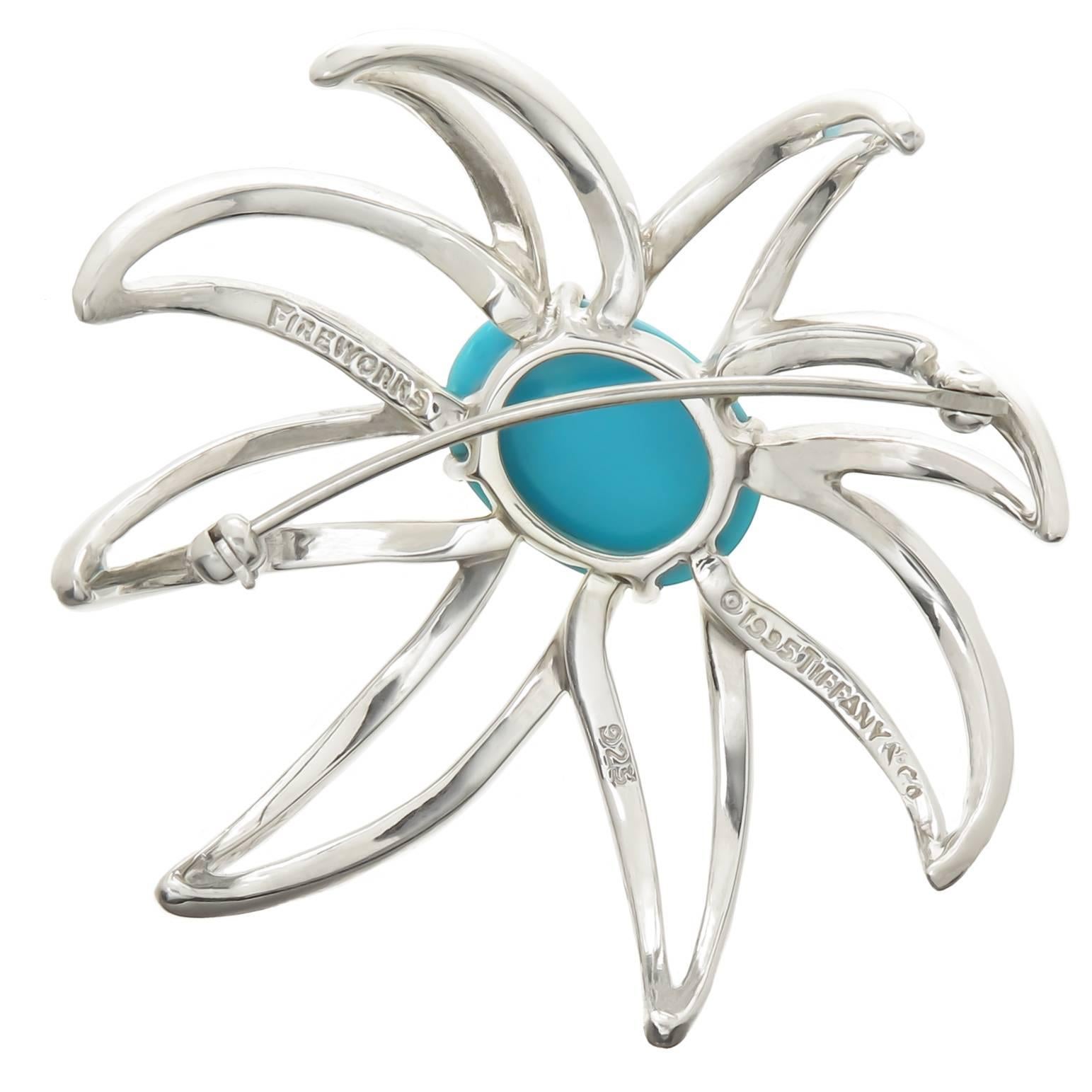 Circa 1995 Tiffany & Company Fireworks collection Sterling silver and Turquoise brooch. Measuring 2 X 2 inches and Centrally set with a Fine Color Persian Turquoise. Excellent Condition.
