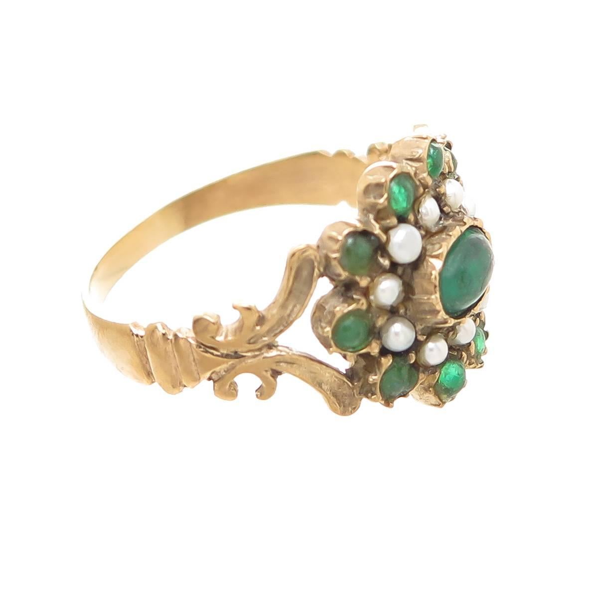 Circa 1850 15K Yellow Gold Georgian ring, set with Cabochon Emeralds and split Pearls. The top of the ring measures 5/8 X 1/2 inch. Finger size = 8 3/4. Very good to excellent condition. 