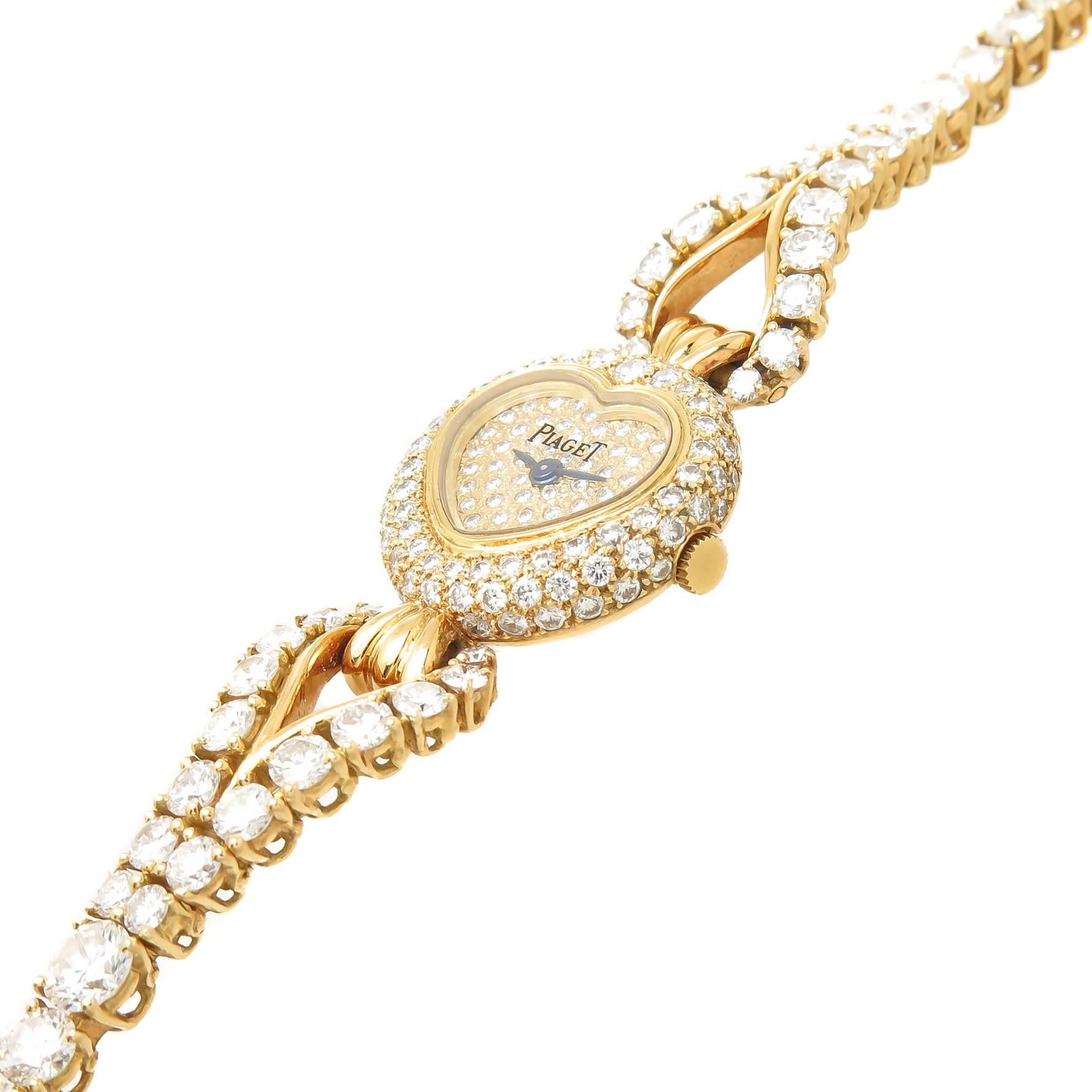 Circa 2005 Piaget Classique Collection Ladies 18K Yellow Gold and Diamond Heart Shape Bracelet Wrist watch. 20 MM watch case Pave set with Diamonds, Quartz Movement, Diamond Pave Heart Shape watch Face. Diamond set Bracelet  with larger Round