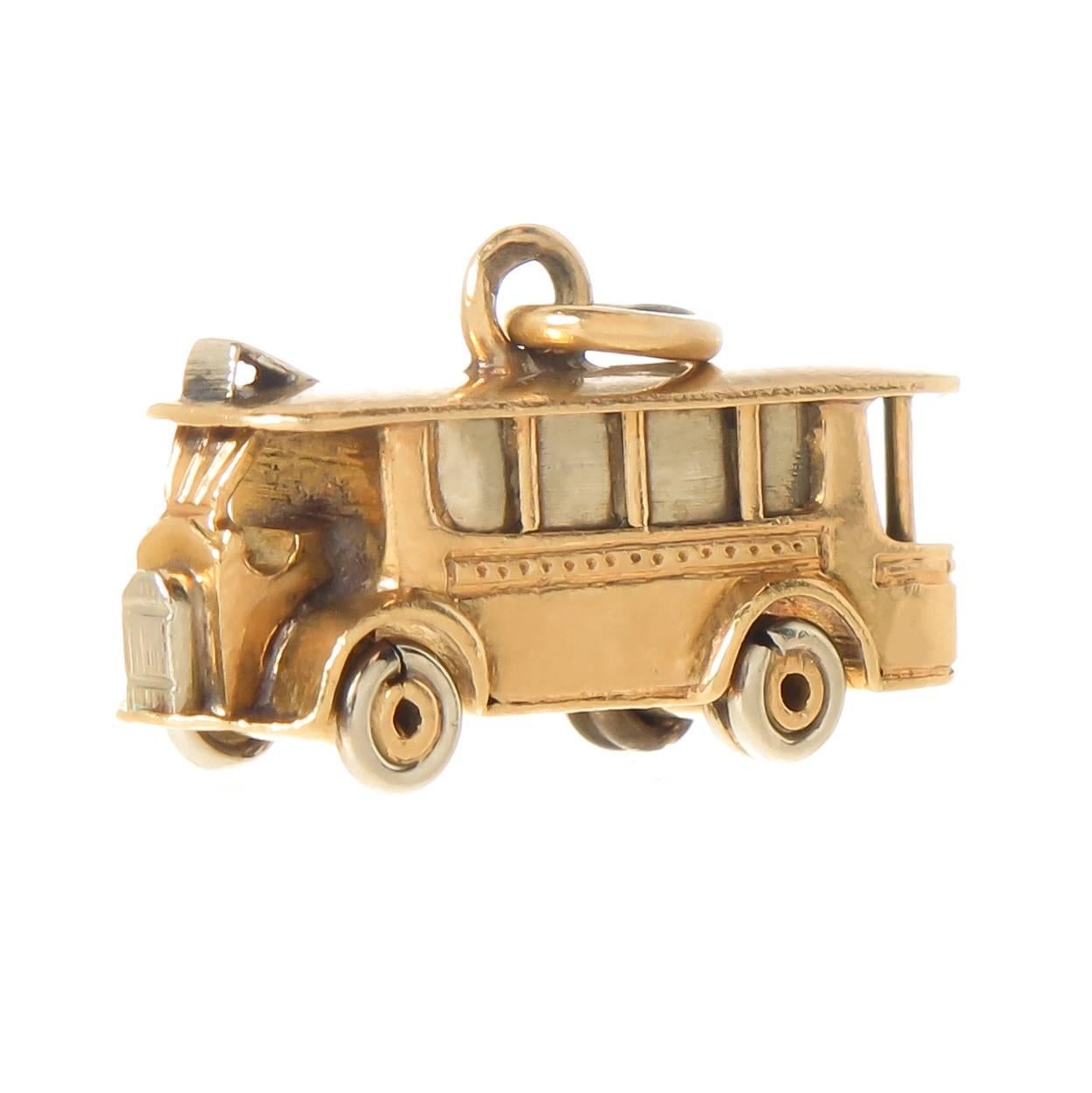 Circa 1950 Cartier 18K yellow Gold Street car Charm, This very detailed charm with moving parts measures 5/8 inch in length and 1/4 inch wide. signed, numbered and never worn this charm comes in the original Gift Box. 