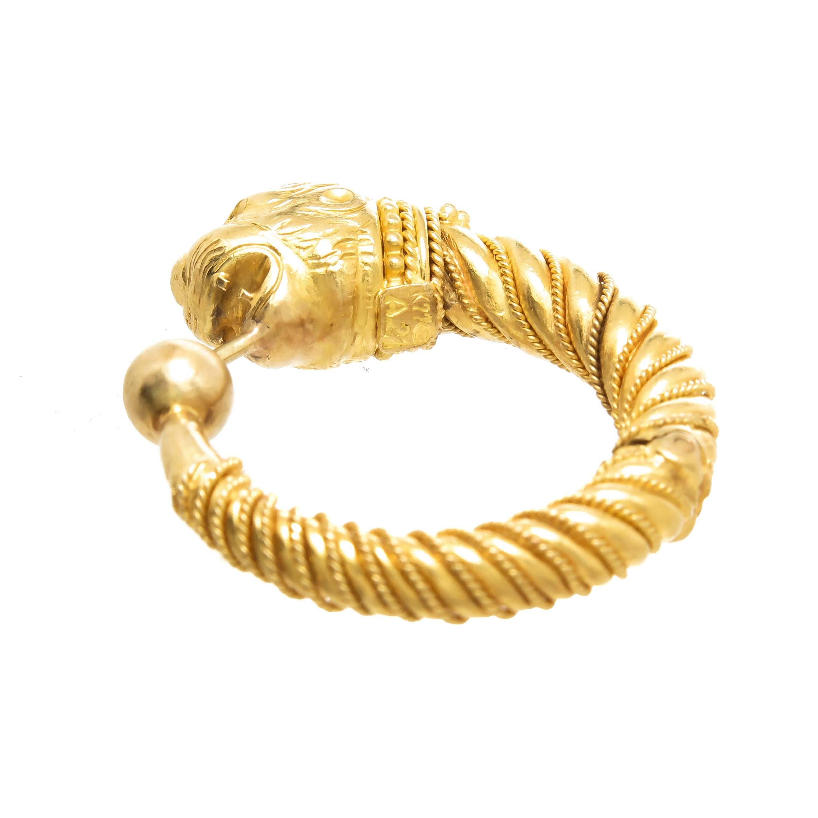 Circa 1980s LaLaounis 22K Yellow Gold Chimera Lion Head Hoop Earrings. Measuring 1 Inch in Diameter, solid construction and having fine detailed Granulation work. The Earrings have a post and a hinge for easy on and off.