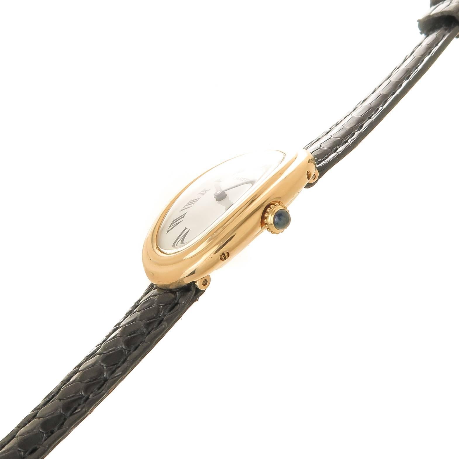 Circa 1980 Cartier Ladies Baignoire Wrist Watch, 31 X 22 MM 18K Yellow Gold Oval case, 6 MM thick. 17 Jewel Mechanical, Manual wind Cartier Movement, White dial with Black roman numerals, sapphire crown. New ( replaced ) Black Lizard strap. Watch
