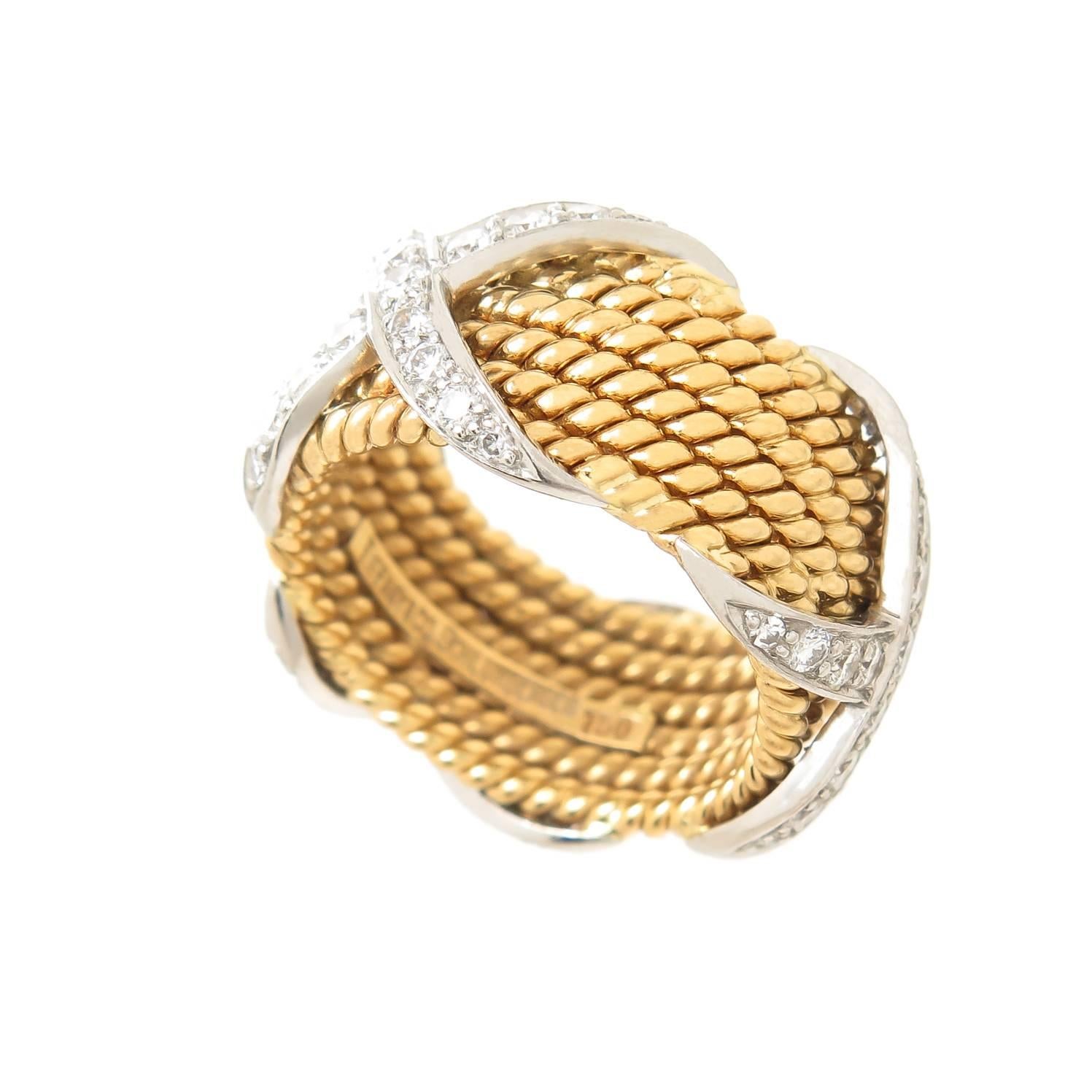 Circa 2000 Jean Schlumberger for Tiffany & Company, 18K Yellow and White Gold 6 row Rope, classic X Ring, set with Round Brilliant cut Diamonds totaling approximately 1 carat and Grading as F-G in color and VS in Clarity. The ring measures 7/16