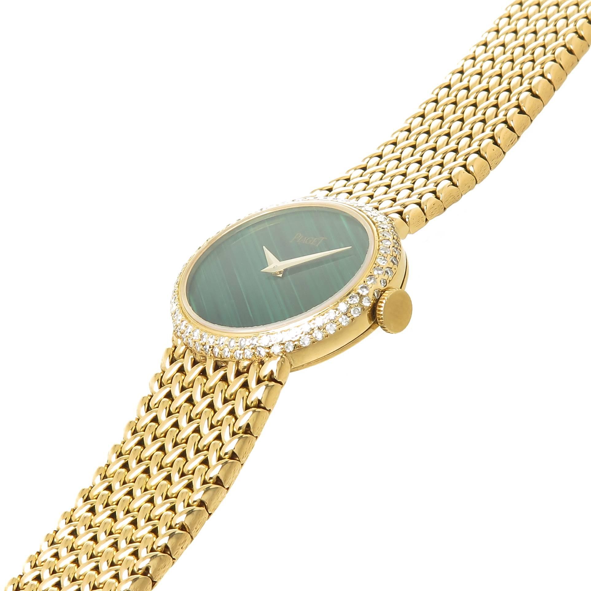 Circa 1970s Piaget Wrist Watch, 16 X 22 MM oval case with original Factory Double row Diamond Bezel totaling approximately 1 Carat. Mechanical, Manual wind 17 Jewel movement, Malachite Dial. 5/8 inch wide Piaget woven Bracelet. Total length 6 Inches