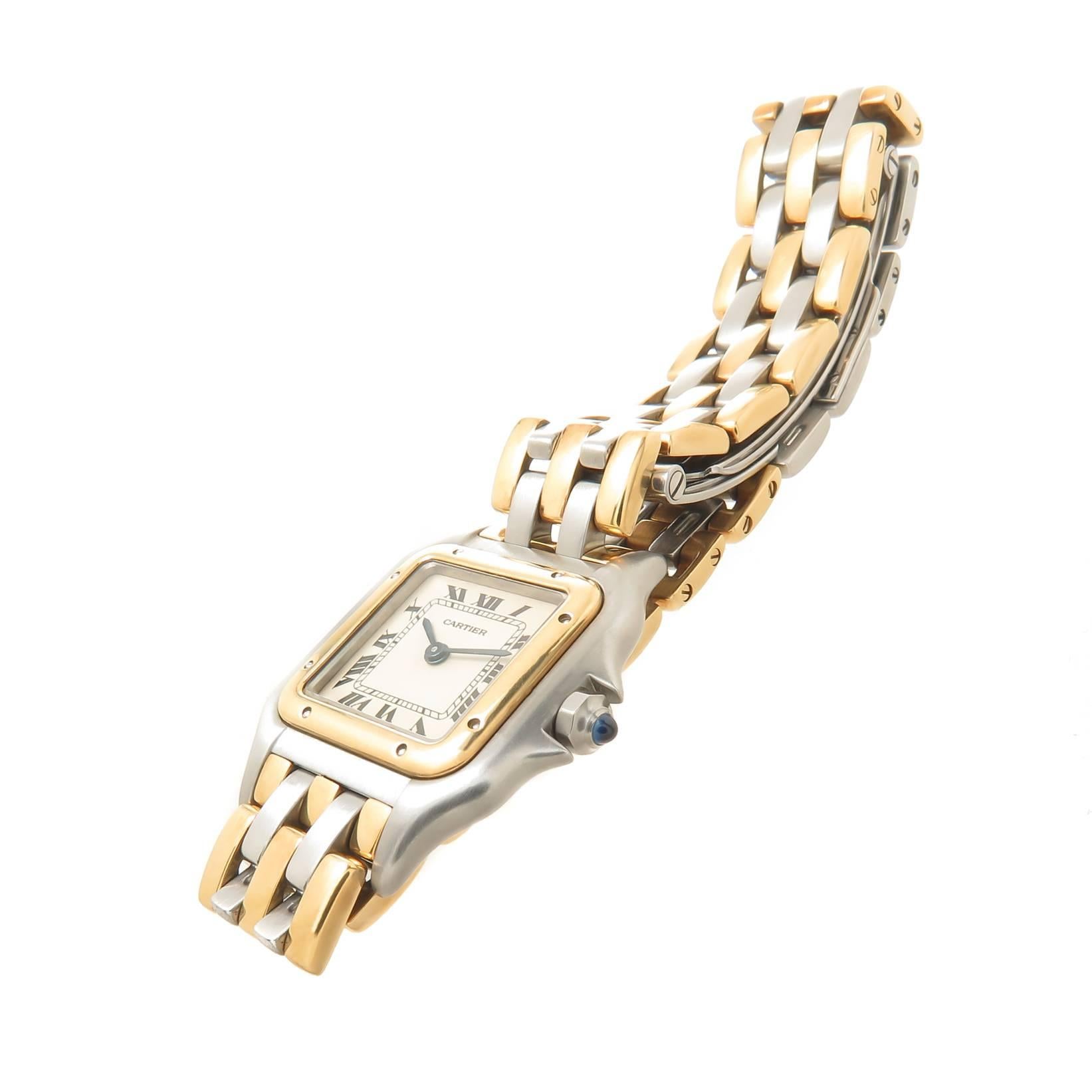 Circa 1990s Cartier Ladies Panther Collection Ladies Wrist Watch, 30 X 23 MM Stainless Steel Water resistant Case with 18K Yellow Gold Bezel, Quartz Movement, White Dial with Black Roman Numerals and a sapphire Crown. 1/2 inch wide " 3 stripe
