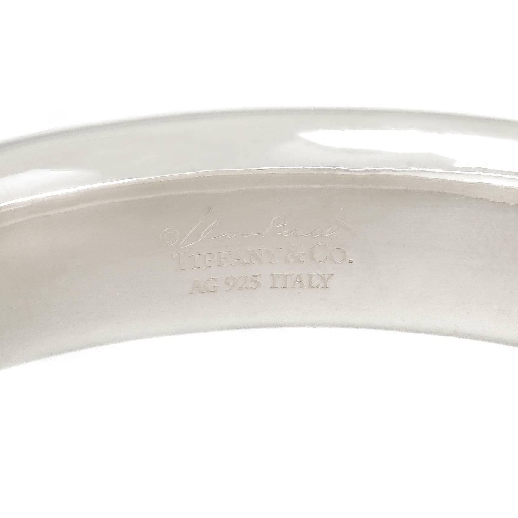 Circa 2012 Elsa Peretti For Tiffany & Co. Sterling Silver round Bangle Bracelet, measuring 5/8 inch wide, 1/4 inch thick and has an inside wrist measurement of 7 1/4 inch. Excellent condition and comes in a Tiffany felt pouch.