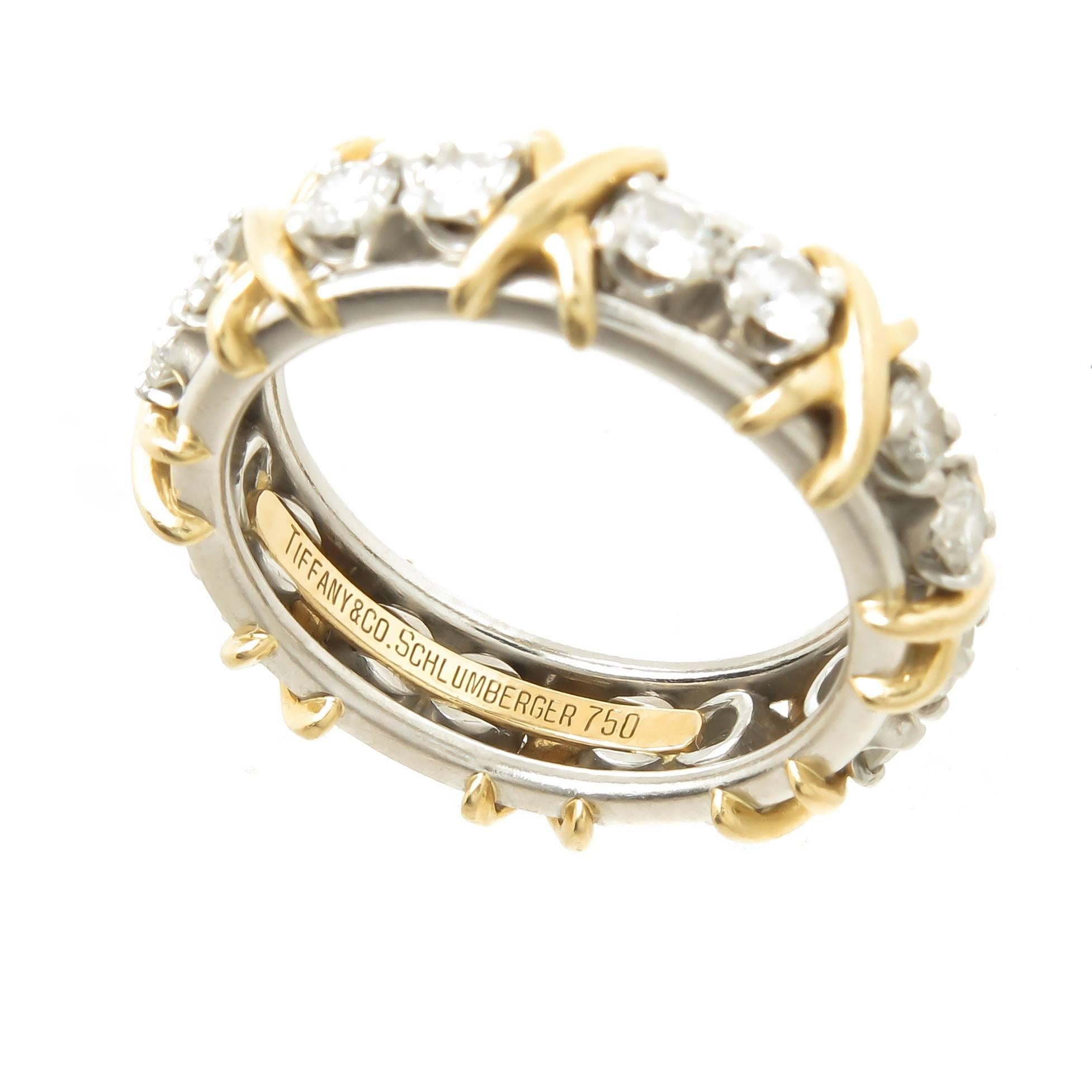 Jean Schlumber for Tiffany & Company, Platinum and 18k Yellow Gold X Band Ring. Set with 18 Round Brilliant cut Diamonds totaling 1.32 Carats and grading as G in color and VS in Clarity. measures 5 MM wide and is a finger size 6 1/2.